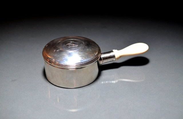 SILVER AND IVORY WARMING PAN: - with central armorial and ivory handle, London, 1770. Underside of lid has later engraving to widow of John Shelley Bar on March 28, 1852. L 17.78 cm. (7 in.).