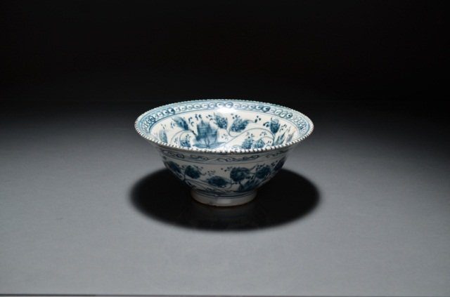 VIETNAMESE BLUE AND WHITE PORCELAIN BOWL: Painted overall with foliages bordered by cloud motives, with scalloped rim. Dia. 19.68 cm. (7 3/4 in.). H 8.89 cm. (3 1/2 in.).