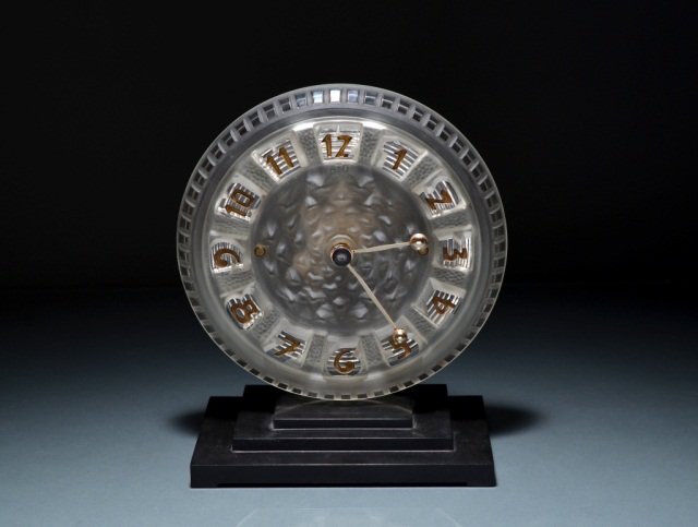 ATO ART DECO CLOCK: - A small moulded glass Art Deco clock by ATO with silver plated hands and black painted numerals. French, c1930s. Marked LEON HATOT, FABRICANTS PARIS, MADE IN FRANCE. Serial # 97874. 8" (20cm)