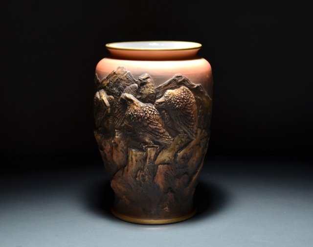 NIPPON MOULDED PORCELAIN VASE: - unusual form with relief decoration of eagles and mountains, for the western market, green M-in-Wreath mark, H: 25.4 cm. (10 in.).