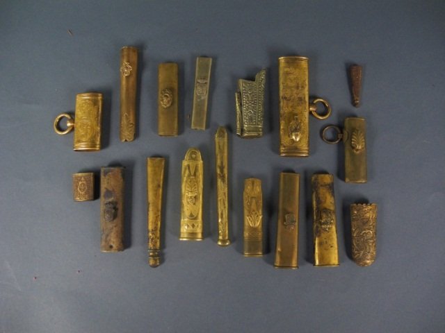VARIOUS WEAPON ACCENTS: - lot comprised of 17 mainly late 19th/ early 20th Century brass accents. Some chapes, some lockets. L of largest: 5 4/8 in, L of smallest:1 1/4 in