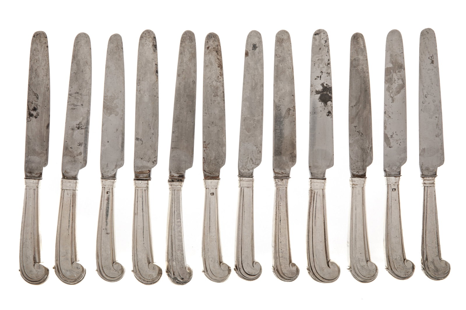 GEORGE III SILVER HANDLED KNIVES: A set of twelve 18th century sterling silver handled knives. The pistol handled knives retain their original blades