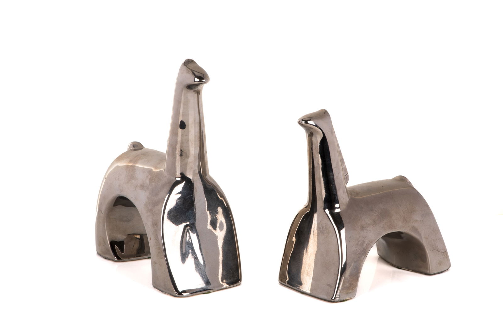 PAIR OF JARU OF CALIFORNIA POTTERY HORSES: Pair of pottery horses by Jaru of California in a reflective chrome glaze. In a modern cubist style. American, mid-20th C. H. of largest: 24 cm (9 1/2")