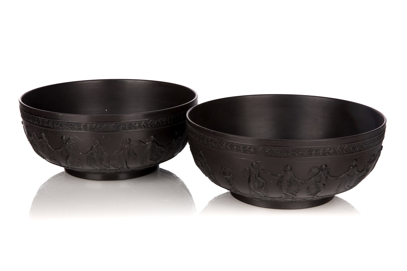 TWO WEDGWOOD 'DANCING HOURS' BLACK BASALT BOWLS: Pair of large black basalt Wedgwood bowls in the Neo-Classical 'Dancing Hours' pattern. Both stamped for Wedgwood to the underside along with the code 'BB9A'. English, 20th C. Dia.: 25.5 cm (10 in.)