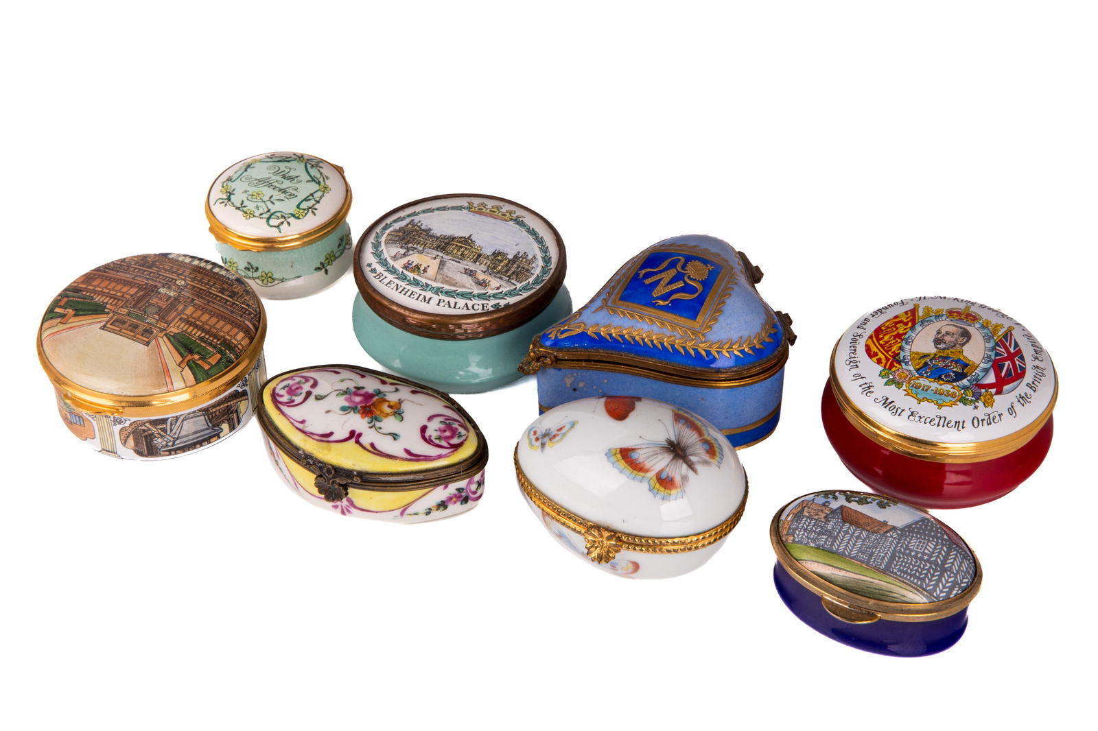 GROUP OF ENAMEL PILL BOXES: A group of eight English and French 20th century enamel boxes depicting various images. Dia of largest 6 cm