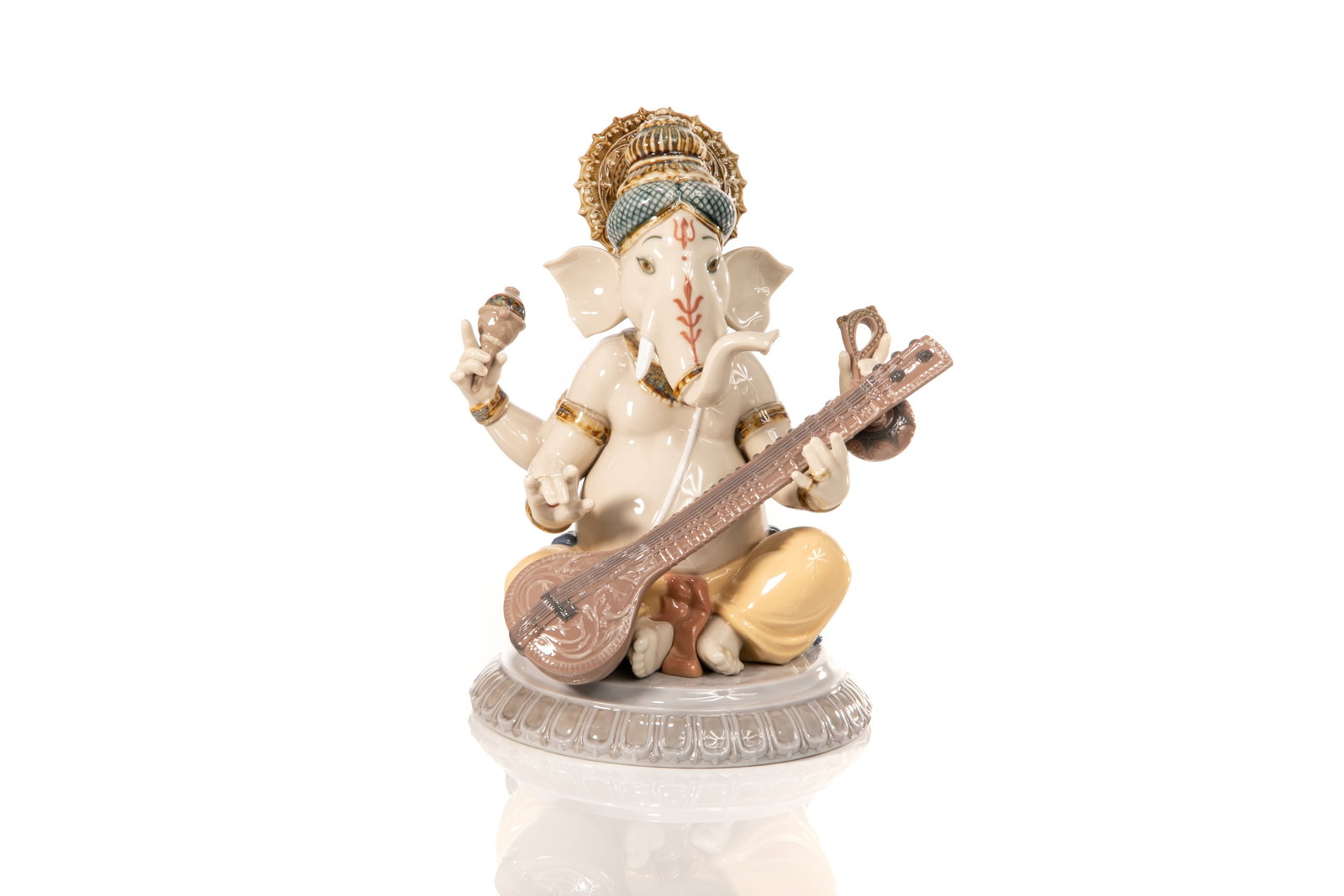 LLADRO PORCELAIN VEENA GANESHA FIGURE: Lladro porcelain figure of Lord Ganesha, the Indian god of wisdom and knowledge. Represented with a human body and the head of an elephant, seated in crossed leg position, playing the Indian guitar (V