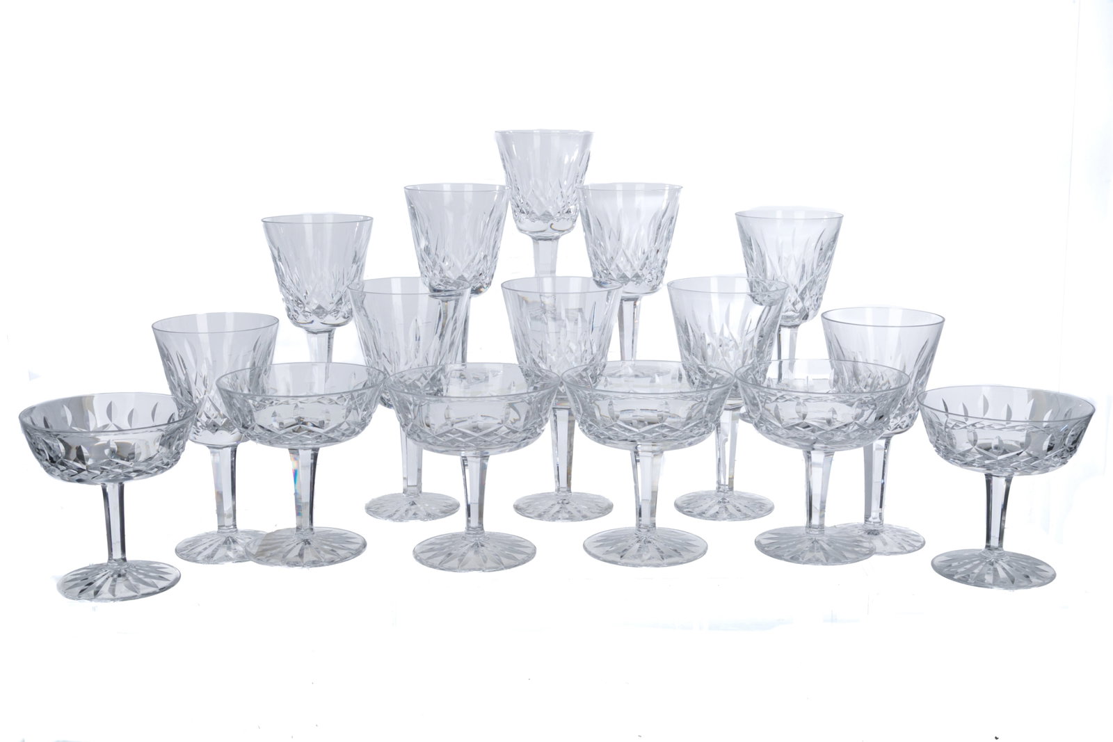 SIXTEEN WATERFORD 'LISMORE' GLASSES: Group of sixteen Waterford glasses in the 'Lismore' pattern. Including six champagne coupes and ten claret wine glasses. Acid etched for Waterford to the underside. Irish, 20th C. H. of claret wine gl