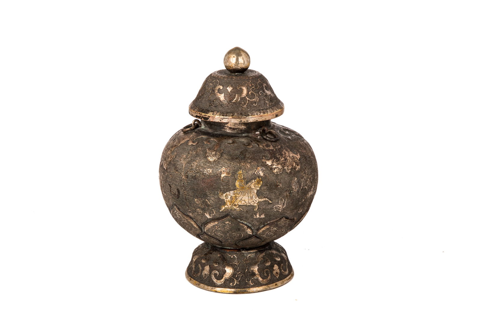 CHINESE LIAO STYLE SILVERED REPOUSSE URN AND COVER: Of baluster form, the body decorated with three equestrians in a landscape in between two foliate bands. Three suspended loose rings to the neck.H. 16.5 cm (6.5 in.)
