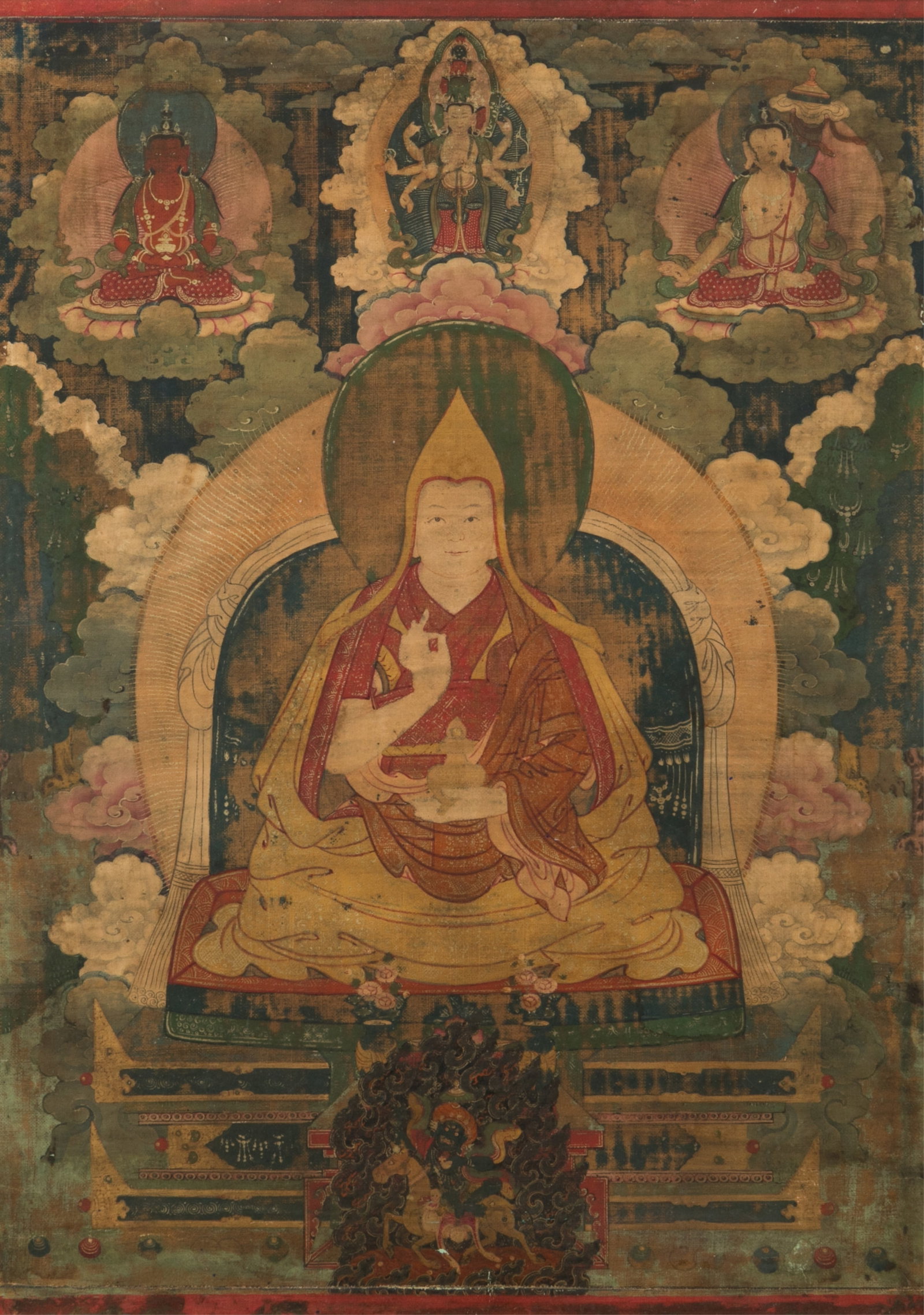 THANGKA PORTRAIT OF TIBETAN BUDDHIST PATRIARCH: Portrait possibly of Khedrub Geleg Pal Zangbo, 1385-1438, one of two sons of Tsongkhapa, circa 1800. Protected above by Amida, Avalokitesvara, Sitatapatra, with a guardian image of Peldenlhamoat the b