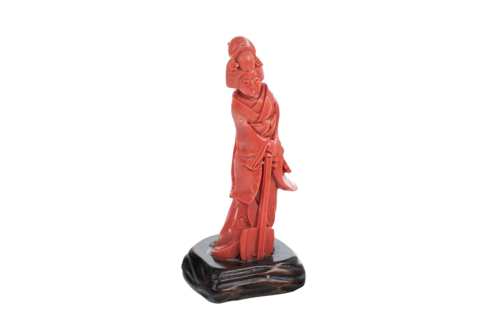 CARVED RED CORAL FIGURE OF A KABUKI: A standing kabuki in kimono and holding a shamisen, on carved wood stand. H. 12.5 cm (5 in.)