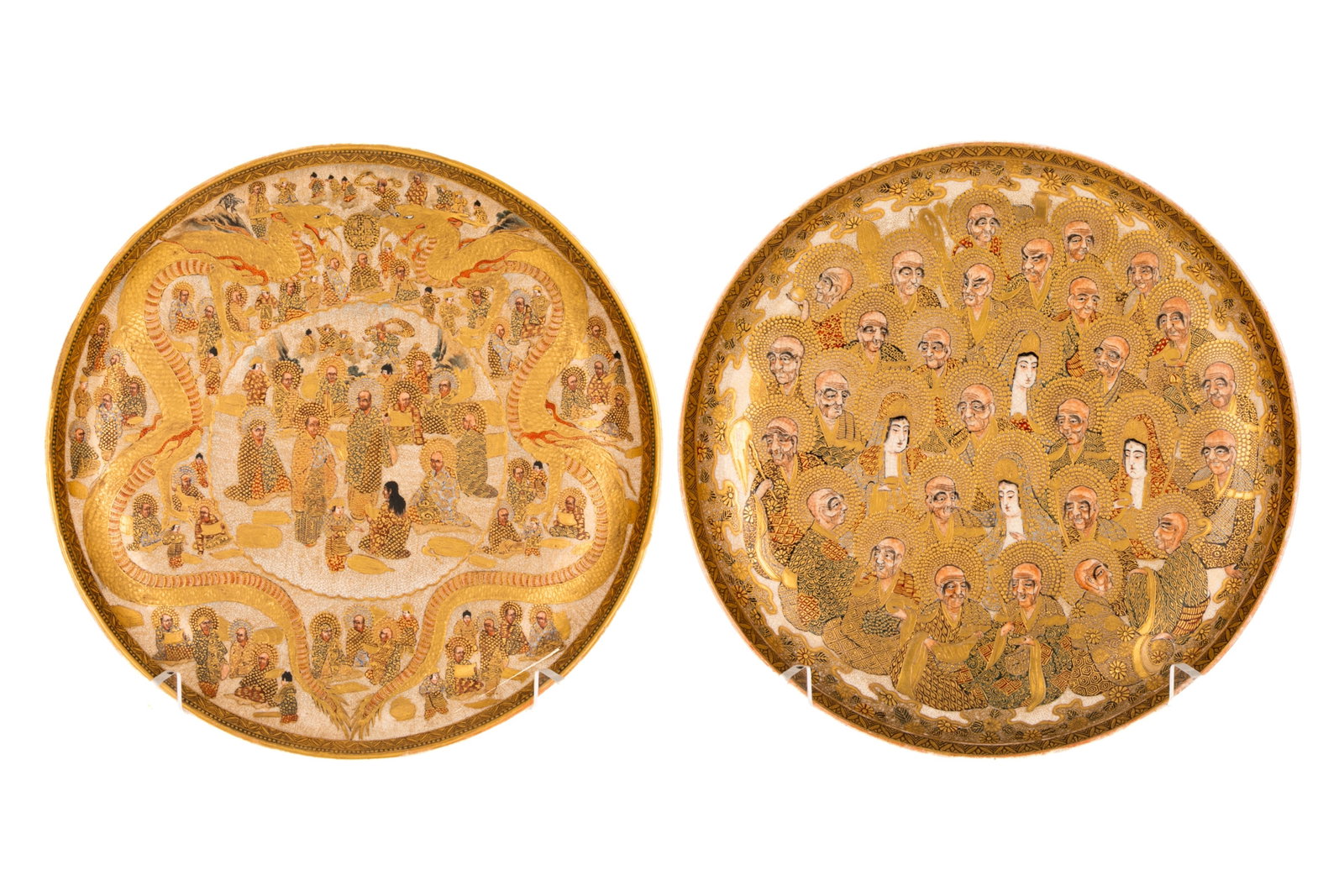 PAIR OF SATSUMA POTTERY CHARGERS: Two Meiji period Japanese satsuma round chargers. Both heavily gilded and decorated with various scholarly scenes and traditional motifs. Marked to the underside of both for (Dai Nihon) Hododa Zo,Seiz