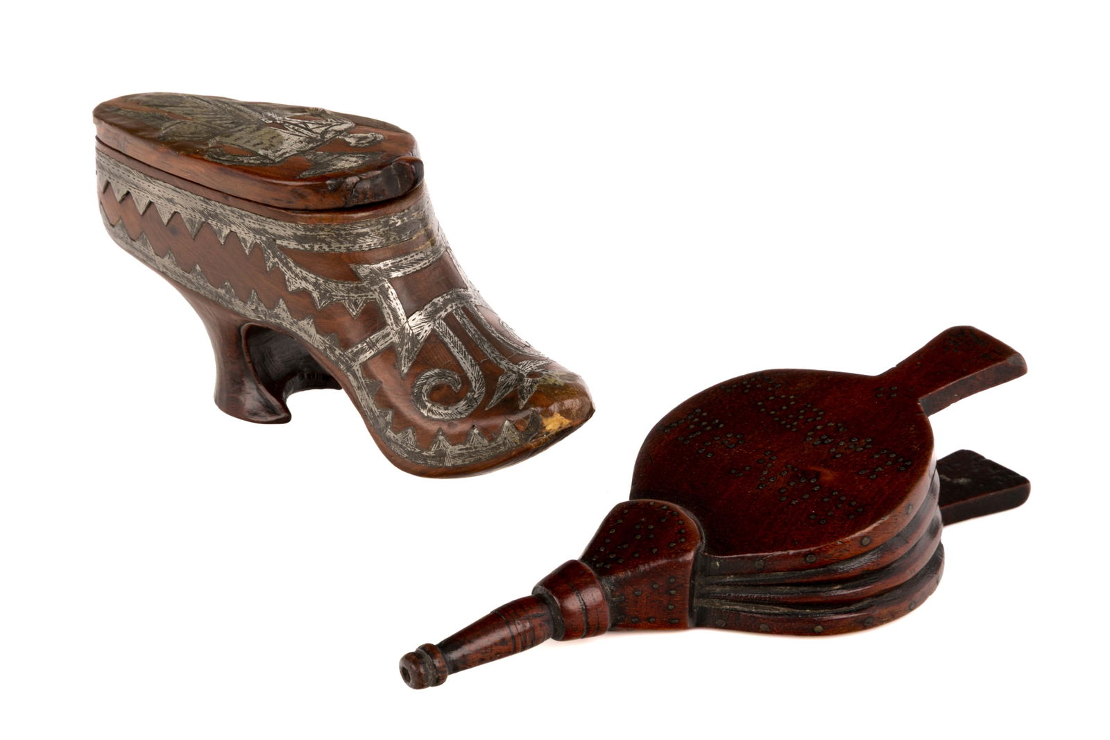 TWO FIGURAL SNUFF BOXES: Two hand-carved figural snuff boxes, one in the shape of a high-heeled shoe with silver inlay mounting and one in the form of a pair of bellows with studs spelling 'Forget Me Not' to theunderside. Lik