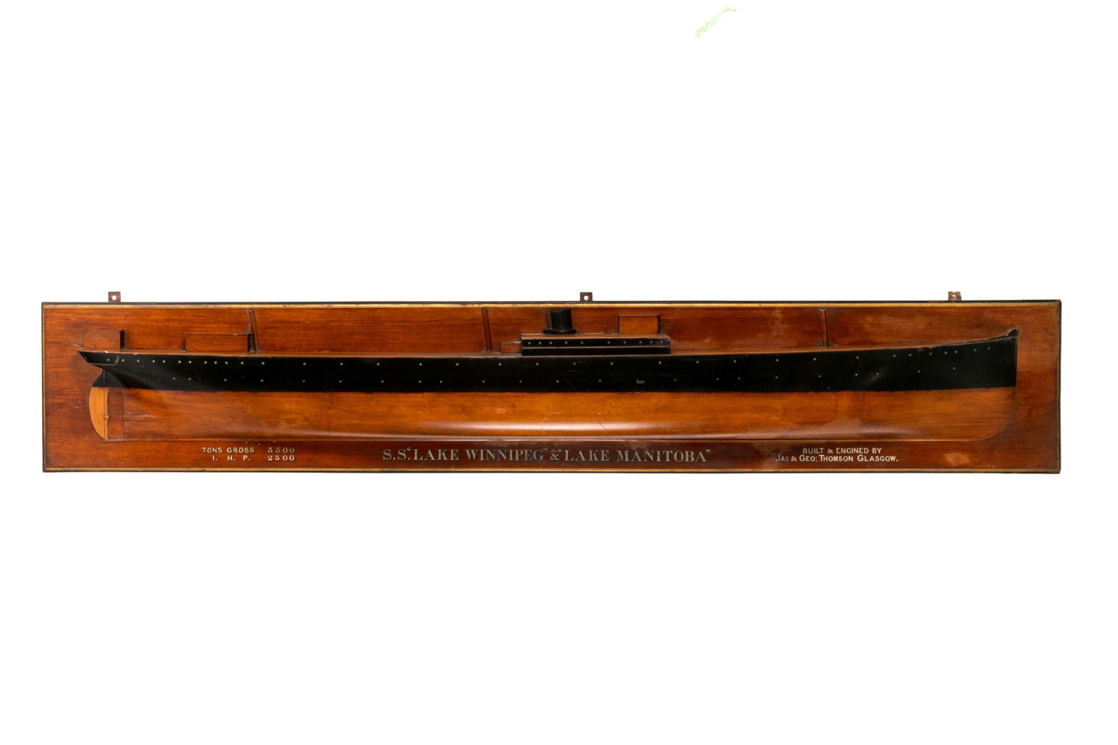 S.S. LAKE WINNIPEG & LAKE MANITOBA HALF HULL MODEL: Large, wooden half hull model for S.S. Lake Winnipeg and S.S. Lake Manitoba. Text painted in three blocks to bottom of wooden plaque. It reads: "Tons Gross 3300 / I.H.P 2500"; "S.S. 'Lake Winnipeg' & 