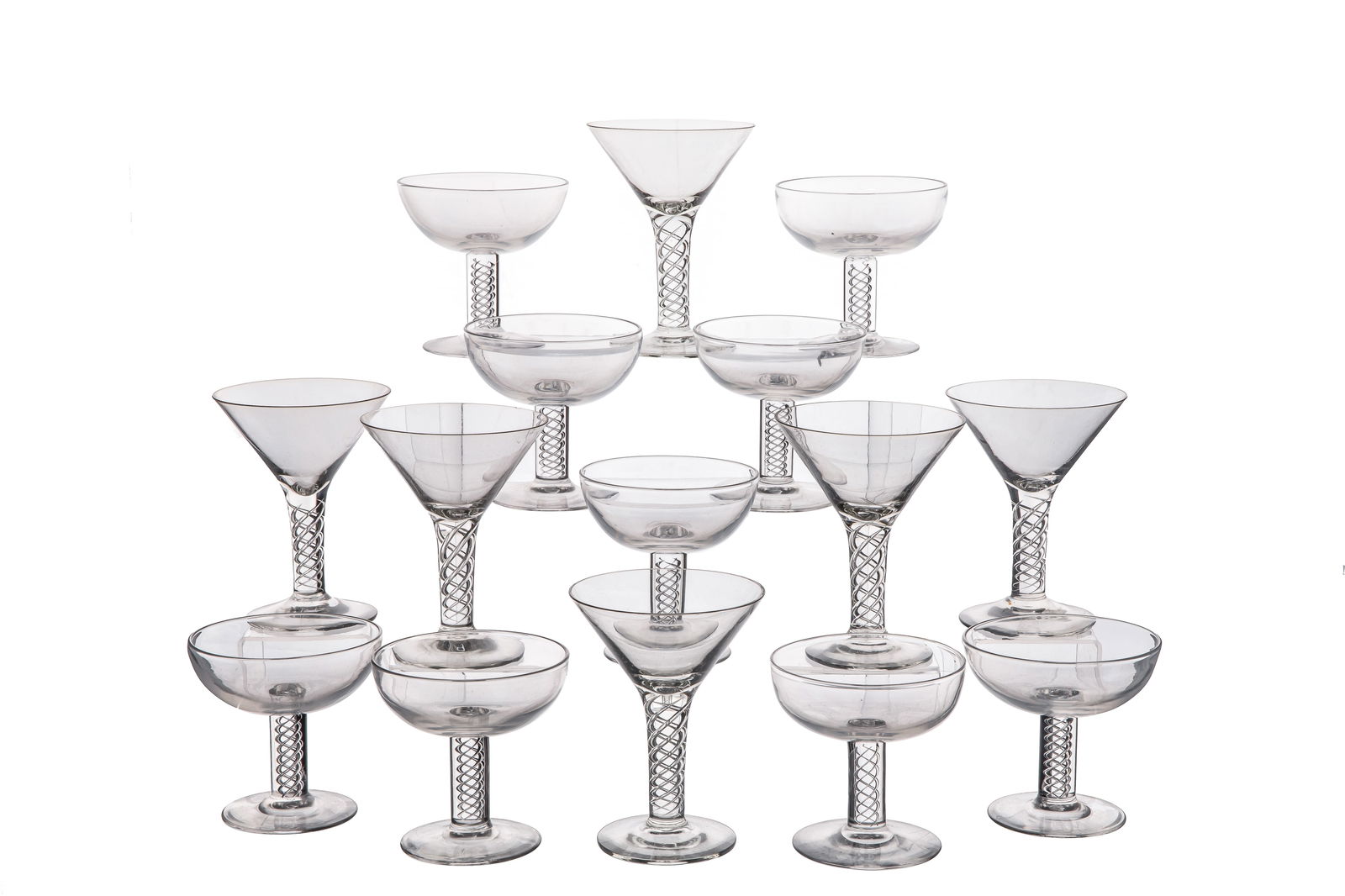 EIGHTEEN STEUBEN GLASSES: Group of eighteen Steuben glass in the '8011' pattern with an air twisted stem and plain bowl. Including champagne coupes and martini glasses. American, 20th C.