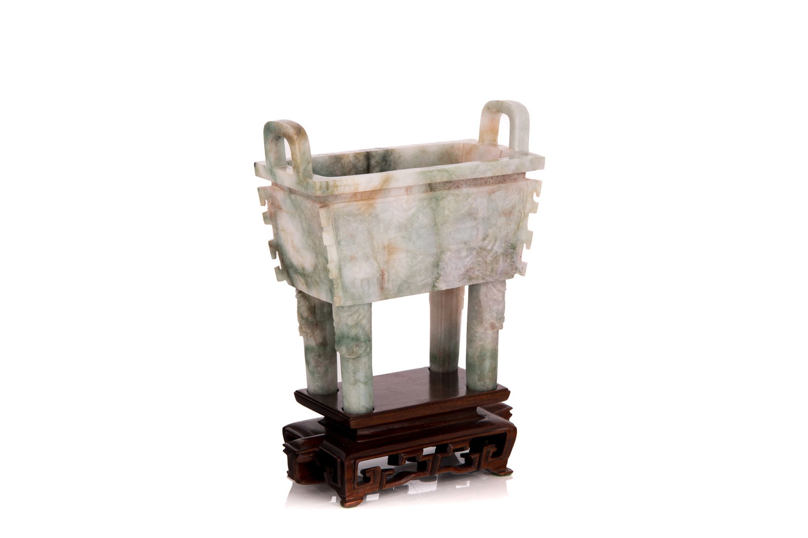 ARCHAISTIC JADEITE CENSER, FANGDING: Raised on four feet with mythical beast mask, the two larger sides of the body decorated with stylized mythical beasts, all four sides carved with protruding flanges, with two upright handles. On carv