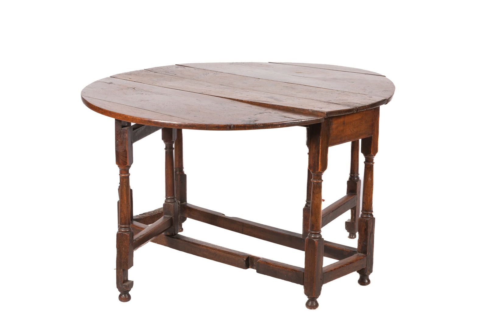 ANTIQUE ENGLISH OAK DROP LEAF GATELEG TABLE: In the traditional form, 18th C. H 27 x W 41 x Dia open 47 1/2in