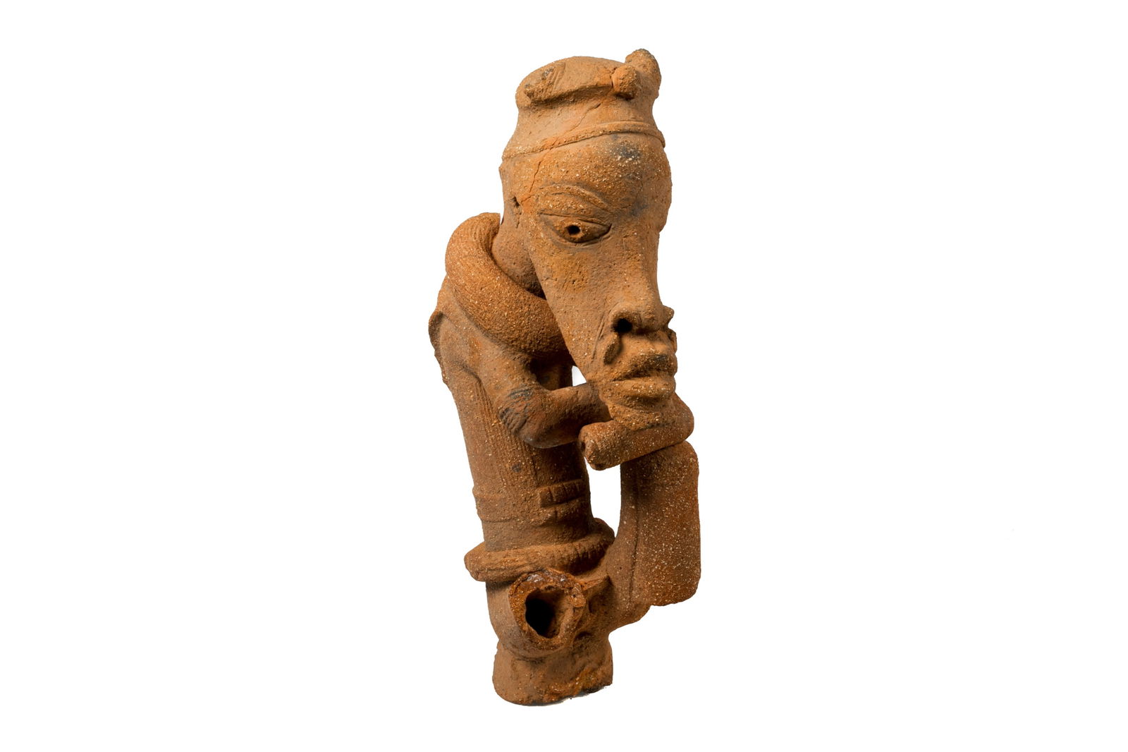 DECORATIVE NOK NIGERIAN TERRACOTTA FIGURE: West Africa, Nigeria, Nok culture. Exact dates unknown, fired clay / terracotta pottery. A stylized seated nude male figure with exaggerated protruding jaw and facial features, abstract headpiece, and