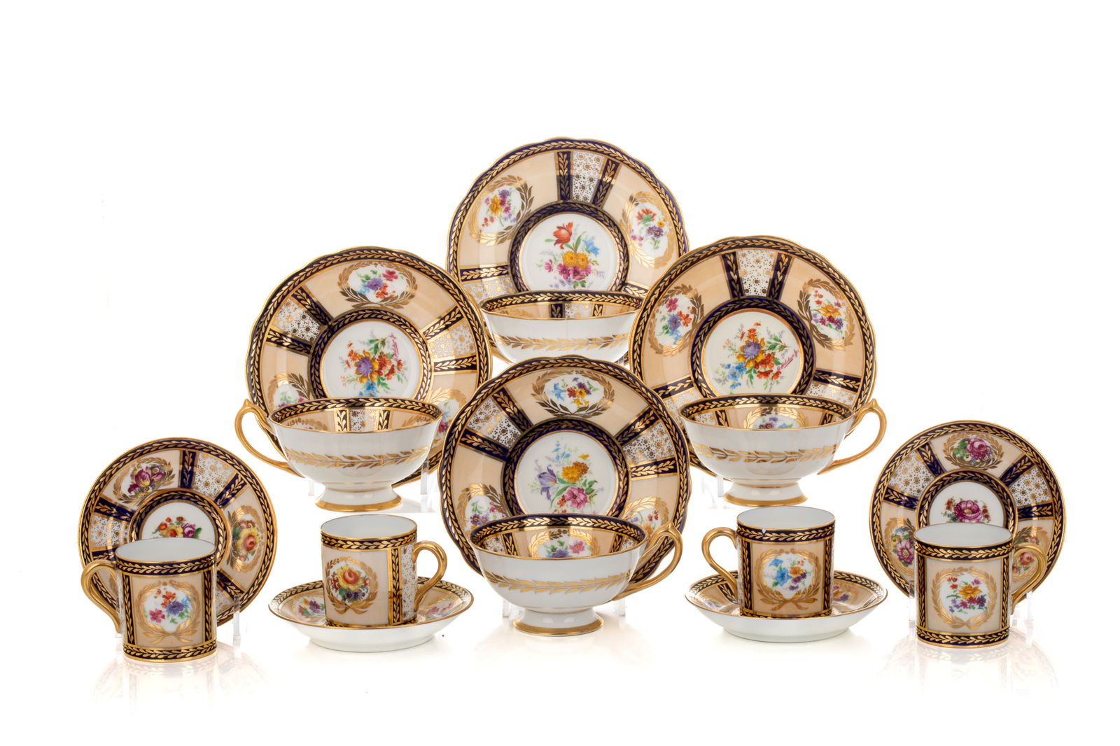 TWENTY TWO PARAGON QUEEN MARY CUPS & SAUCERS: Including twelve tea cups and saucers and ten demi tasse cups and saucers. The service named for Her Majesty Queen Mary, produced between 1939 and 1949.