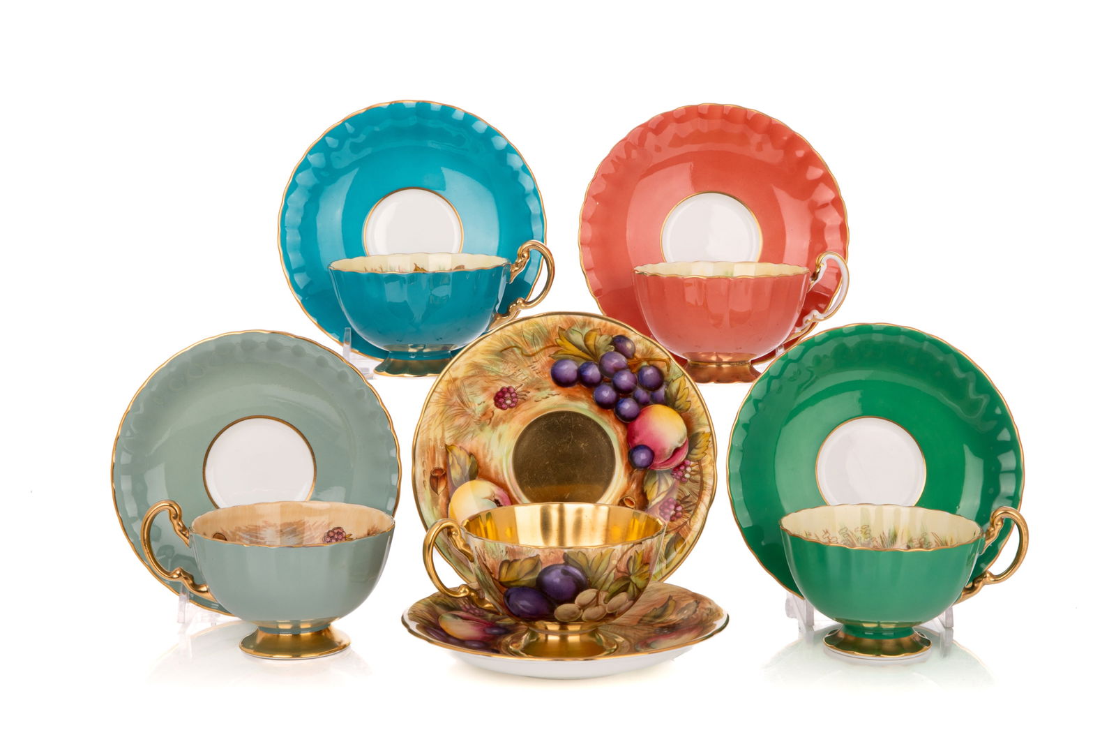 FIVE ENGLISH PORCELAIN TEA CUPS & SAUCERS: Aynsley harlequin coloured cups and saucers with fruit interiors, and a fruit & gold with extra saucer.