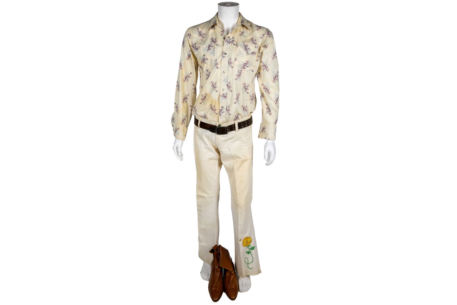 LIGHFOOT'S VINTAGE OUTFIT: White denim pants with an embroidered yellow flower, well worn shirt with purple flowers, belt and leather low boots.