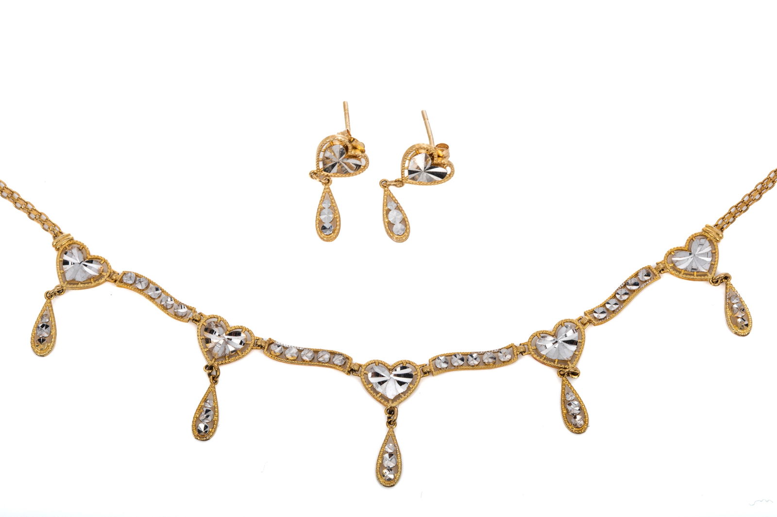 10K PEOPLES HEART EARRINGS & NECKLACE SET 5.1g: 10K yellow gold and rhodium heart necklace measuring 17.5 inches long. Matching stud earrings measuring 20mm long. 5.1 grams