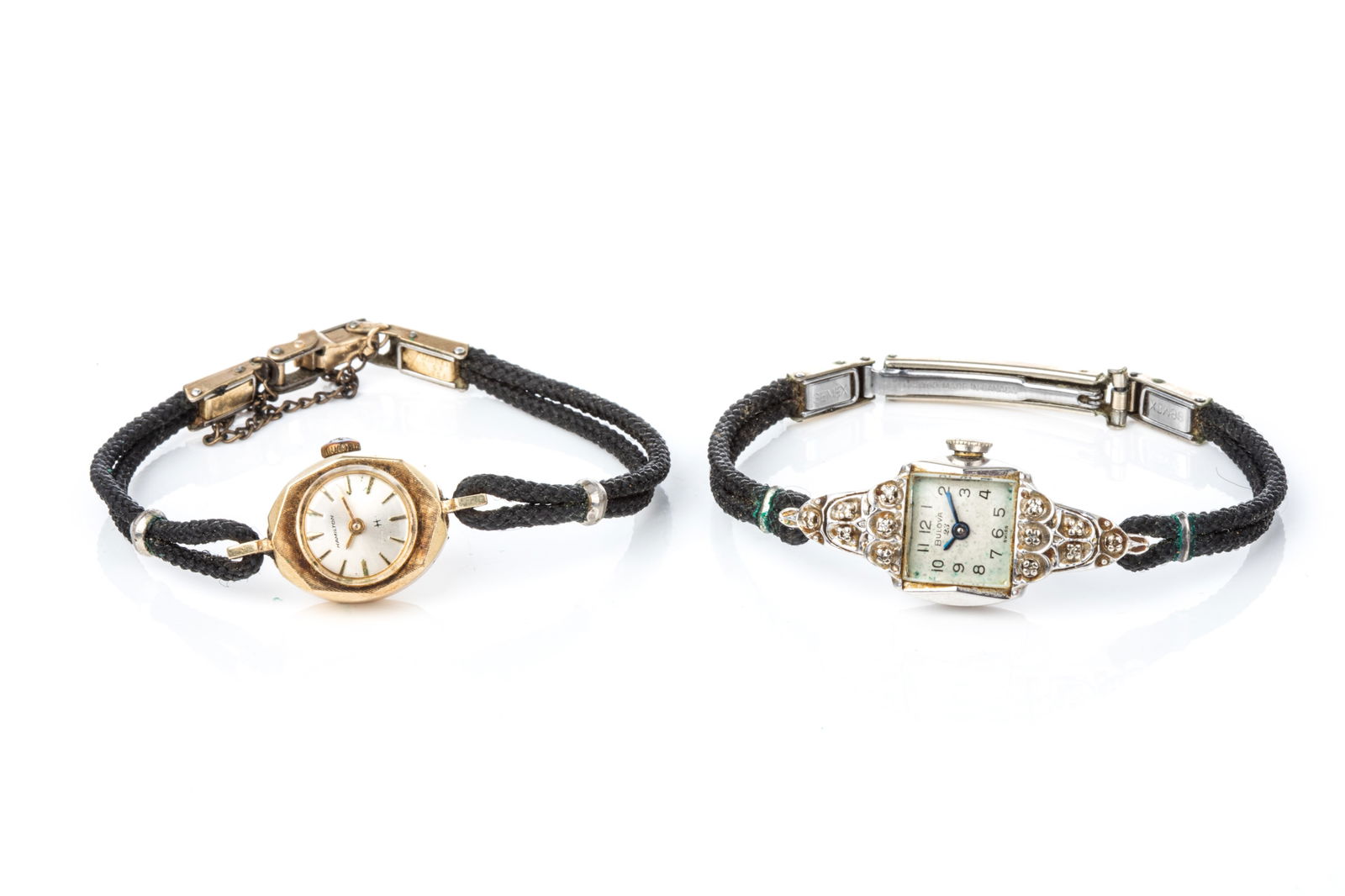 TWO 14K GOLD COCKTAIL WATCHES: 14K yellow gold ladies Hamilton cocktail watch on black cord with base metal clasp. Not running. 8.9 grams (total) 14K white gold and round single cut diamond Bulova cocktail watch on black cord with