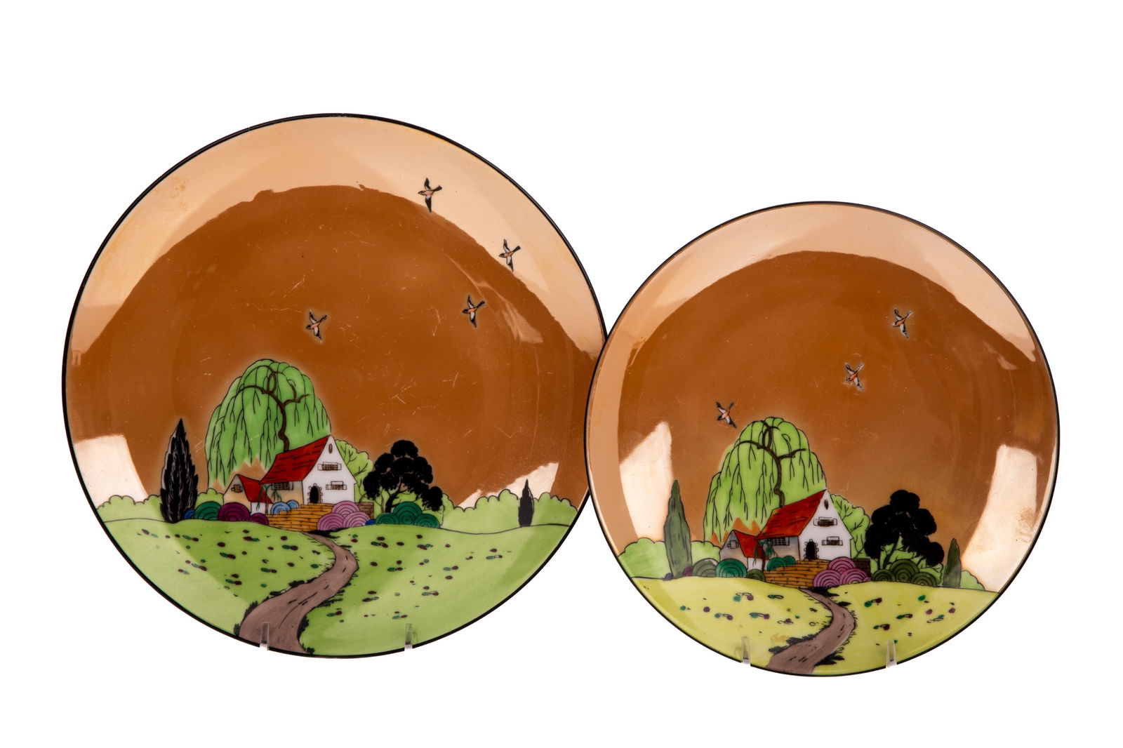 TWO ART DECO LUSTRE NORITAKE PLATES: Each with a house and landscape motif. Smallest Dia. 8 1/2" (21.5cm) Largest Dia. 9 3/4" (25cm)