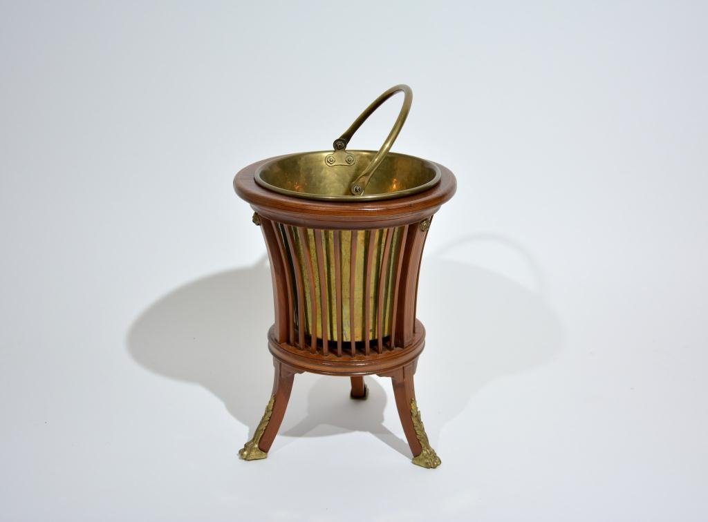 EDWARDIAN COAL SCUTTLE BASKET: Reeded mahogany and inlay basket on ormolu mounted feet with fitted brass interior. Dia 14 inches.