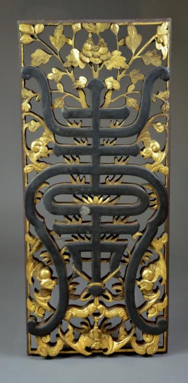 CHINESE CARVED LACQUER AND GILT WOOD PANEL: Rectangular panel carved with stylized Shou character in centre surrounded by gilt floral motifs and bats, late 19th century. H 76.5 cm. (30 1/7 in.)