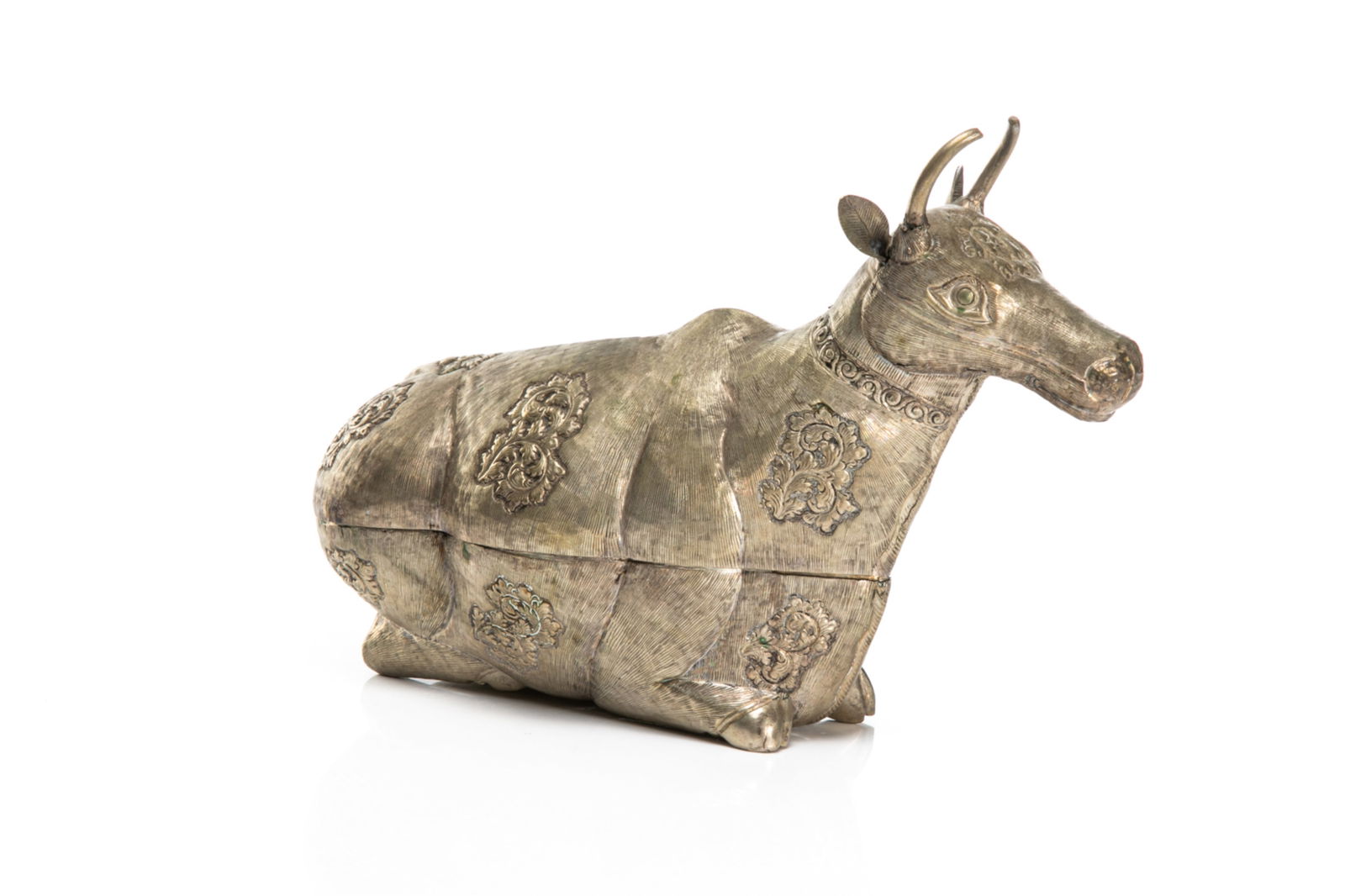 LARGE ANTIQUE CAMBODIAN SILVER COW (368g): Resting in an upright position, body decorated with fine hair details and repousse floral patterns. Stamp mark to base. Weight 368g.