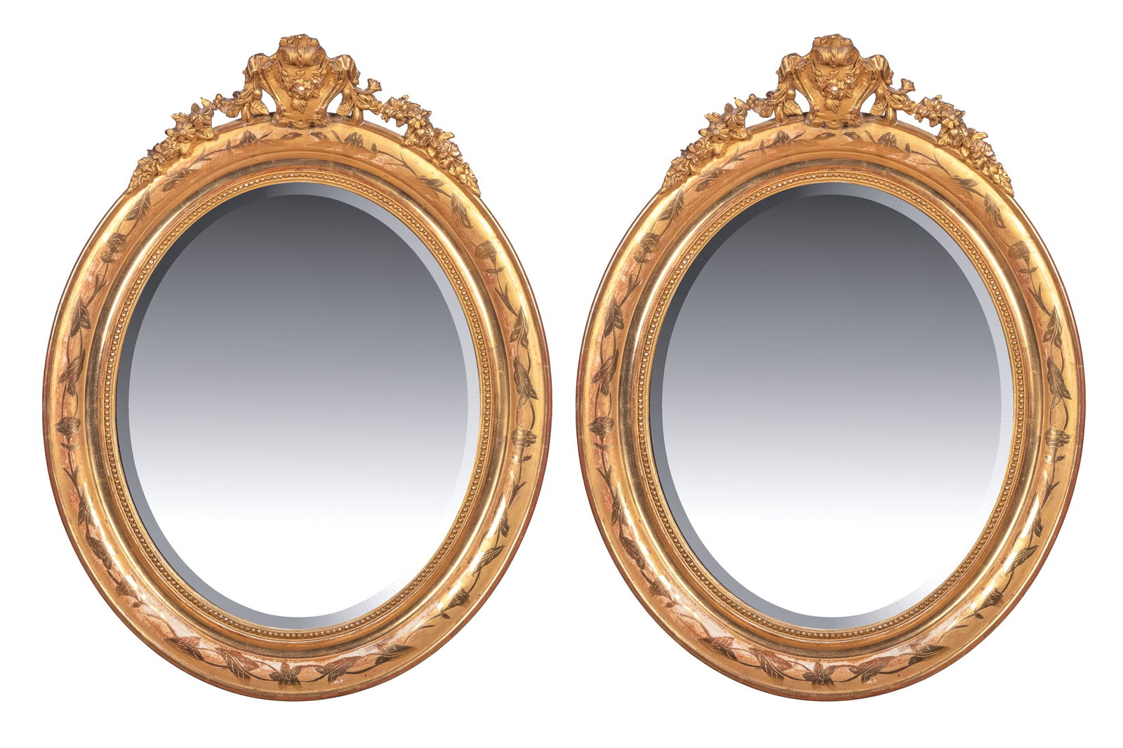 PAIR OF GILDED ANTIQUE FRENCH OVAL MIRRORS: Oval parcel gilt and decorated with beveled glass, 19th C. H. 26" x W. 20"