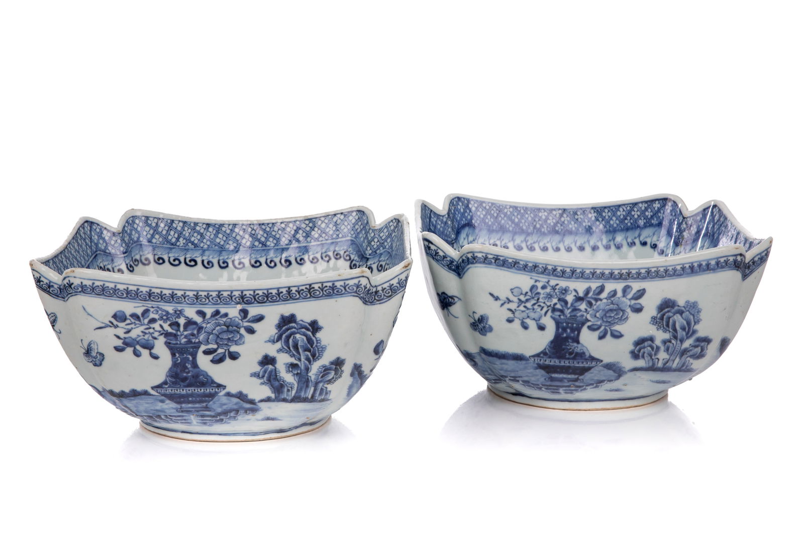 PAIR CHINESE BLUE & WHITE PORCELAIN SQUARE BOWLS: Of scalloped square section, the exterior decorated with a continuous landscape of flowers, fruits, birds and butterflies. The cavetto with a floral spray and the rim with a stylized foliatediaper pat
