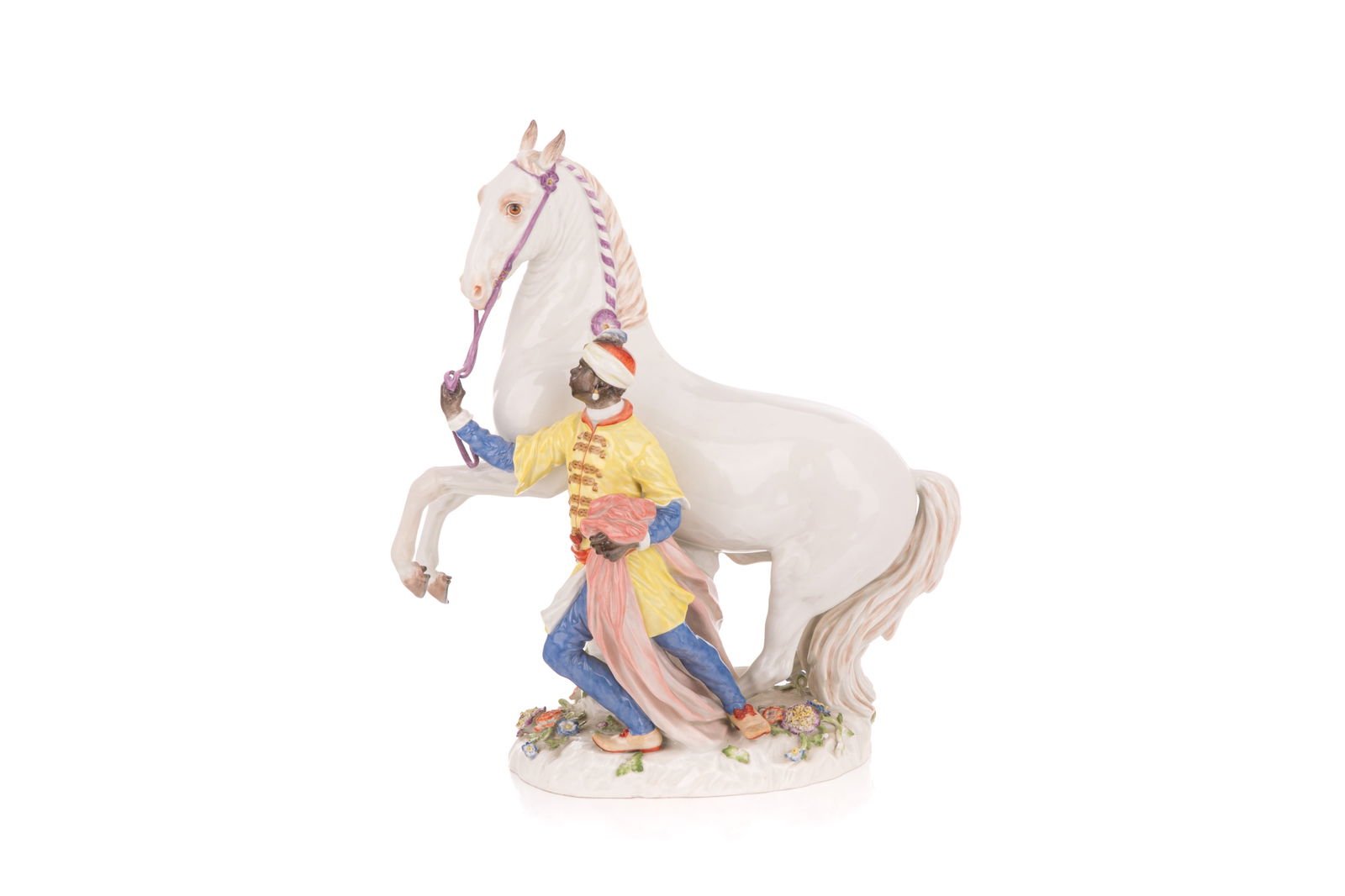 MEISSEN FIGURAL GROUP OF WHITE HORSE & GROOMSMAN: Large white porcelain rearing horse with floral sprays around the base, colourfully dressed man rearing. After the Kandler model.H 17" (43 cm) x W 15" (38 cm)