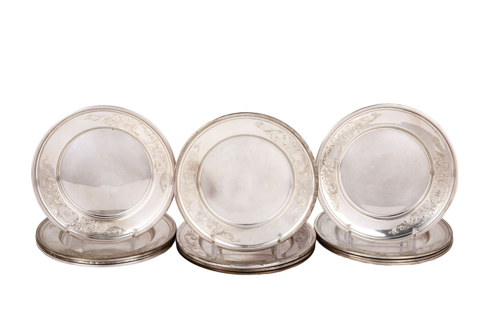 12 BIRKS STERLING SILVER SMALL PLATES, 969g: A set of twelve Birks sterling silver side plates. Each engraved with a foliate pattern around a central escutcheon.