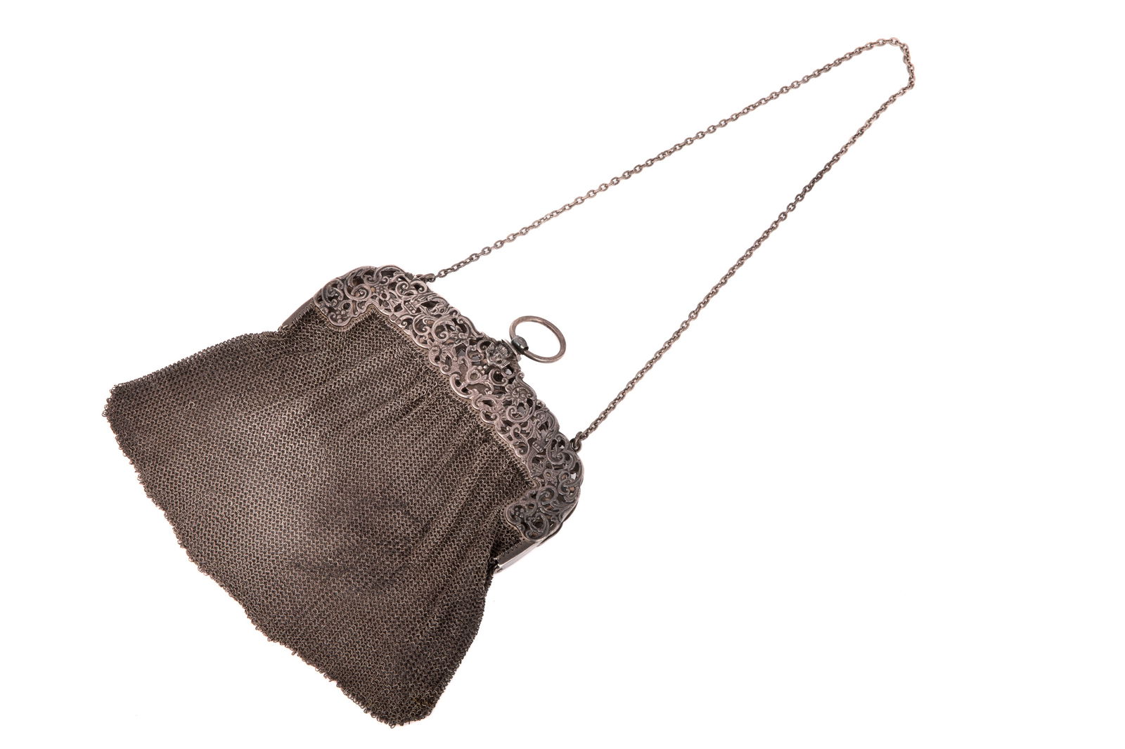 ANTIQUE MESH SILVER HANDBAG 330g: An antique silver mesh handbag with reticulated floral decoration, small angel decoration at the clasp, cable chain, marked SJ.L. 20cm (7 7/8 in.)