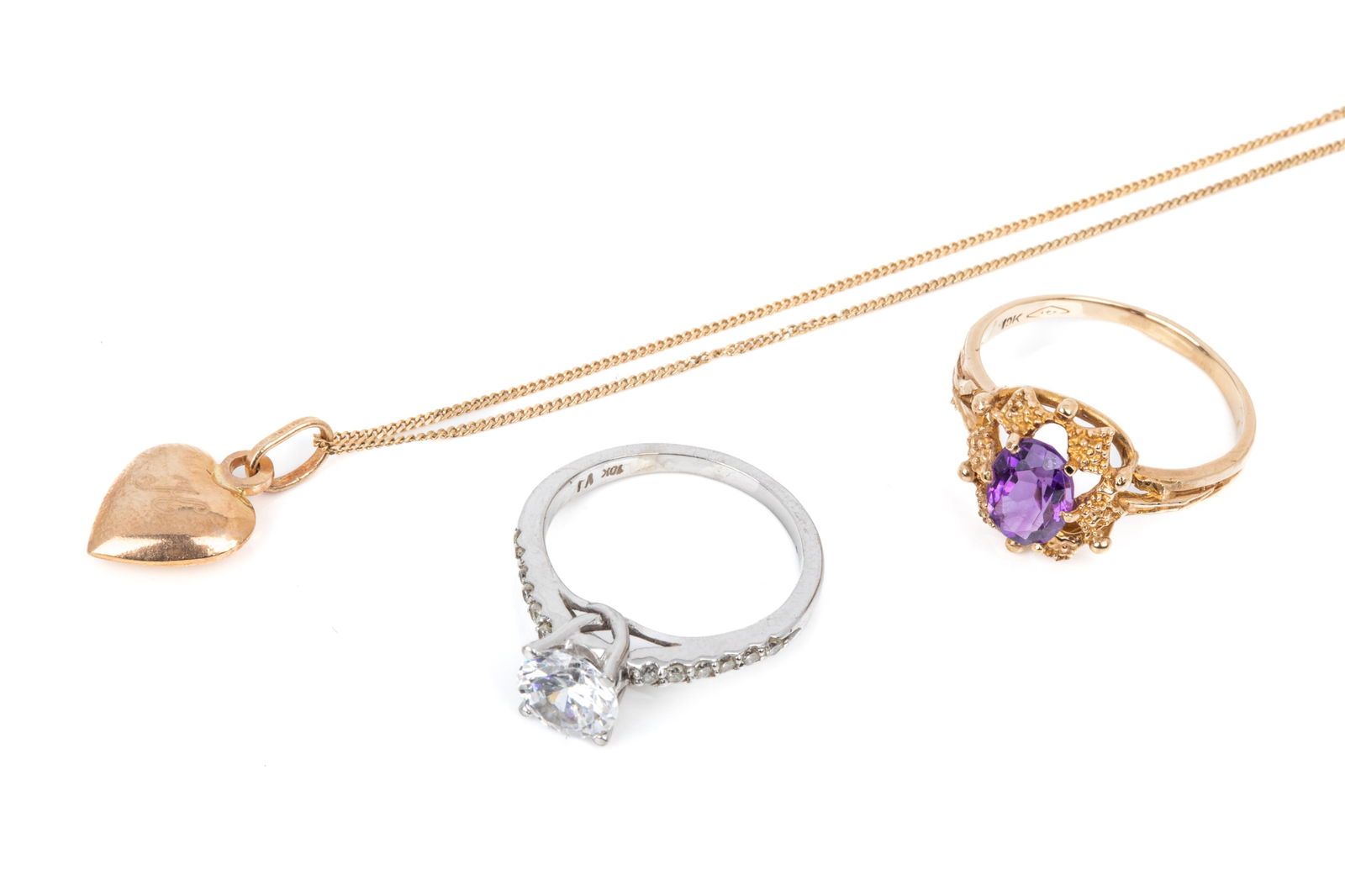 14K & 10K JEWELLERY GROUPING 7.8g: 14K yellow gold puffed heart pendant measuring 18mm long (with bail), engraved "K", accompanied by 16 inch long chain. 2.2 grams10K yellow gold amethyst ring measuring 12.9mm wide. Size 8.5 2.6