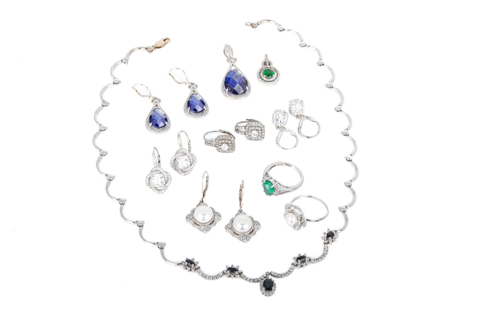 DRESSY 925 SILVER GROUPING 63.1g: 17.25 inch long scalloped necklace. Featuring 5 oval faceted very dark to dark blue sapphires, moderately to heavily included. Accented by round brilliant cut diamonds of I1-HIJK quality.19.6