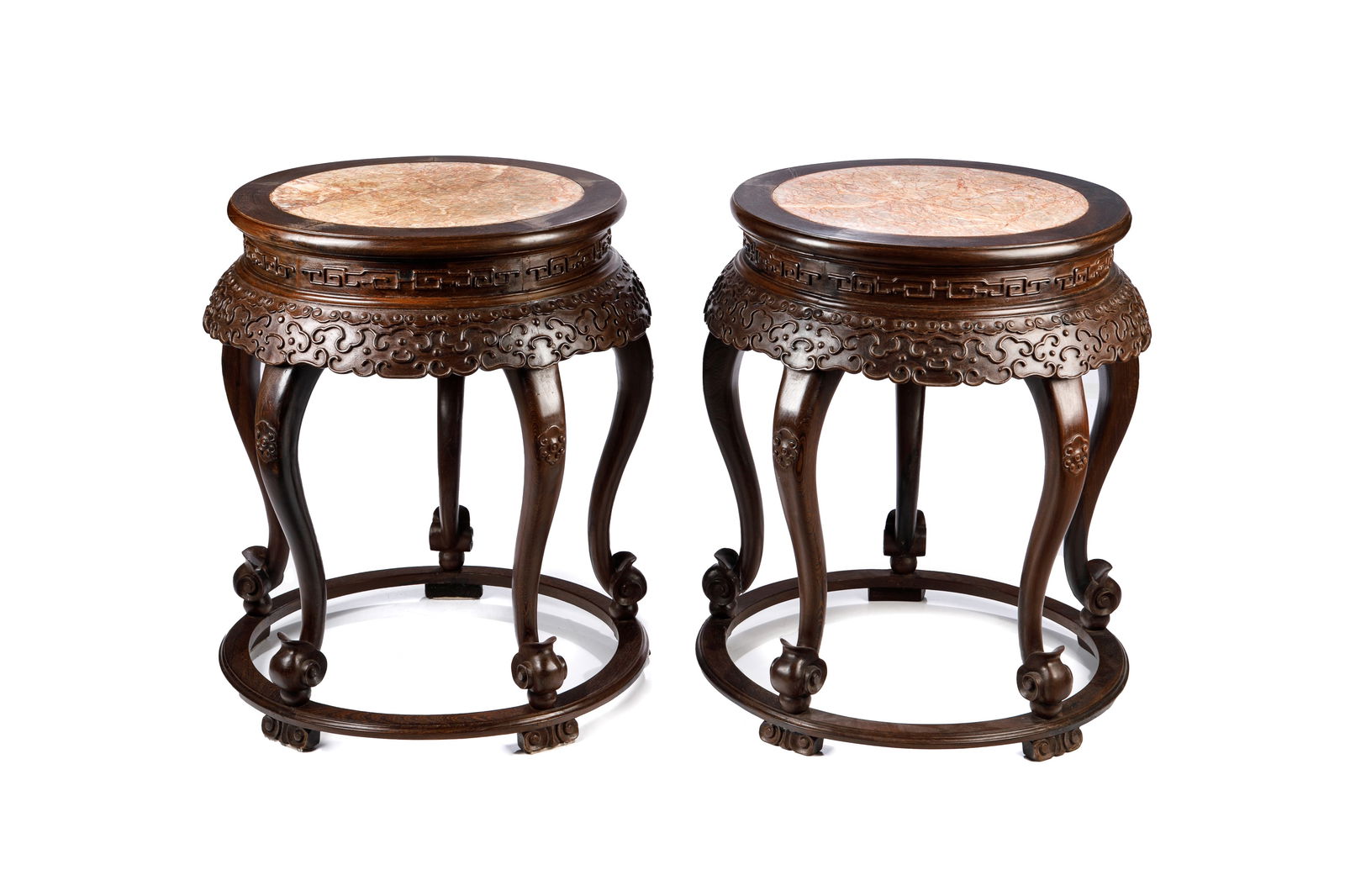 PAIR OF CHINESE PEDESTAL STANDS WITH MARBLE: Chinese, 20th century, having round orange and white stone inserts on top, the apron with carved scrolling cloud detail in low relief, having five cabriole legs, connected by stretcher at base. H. 28"