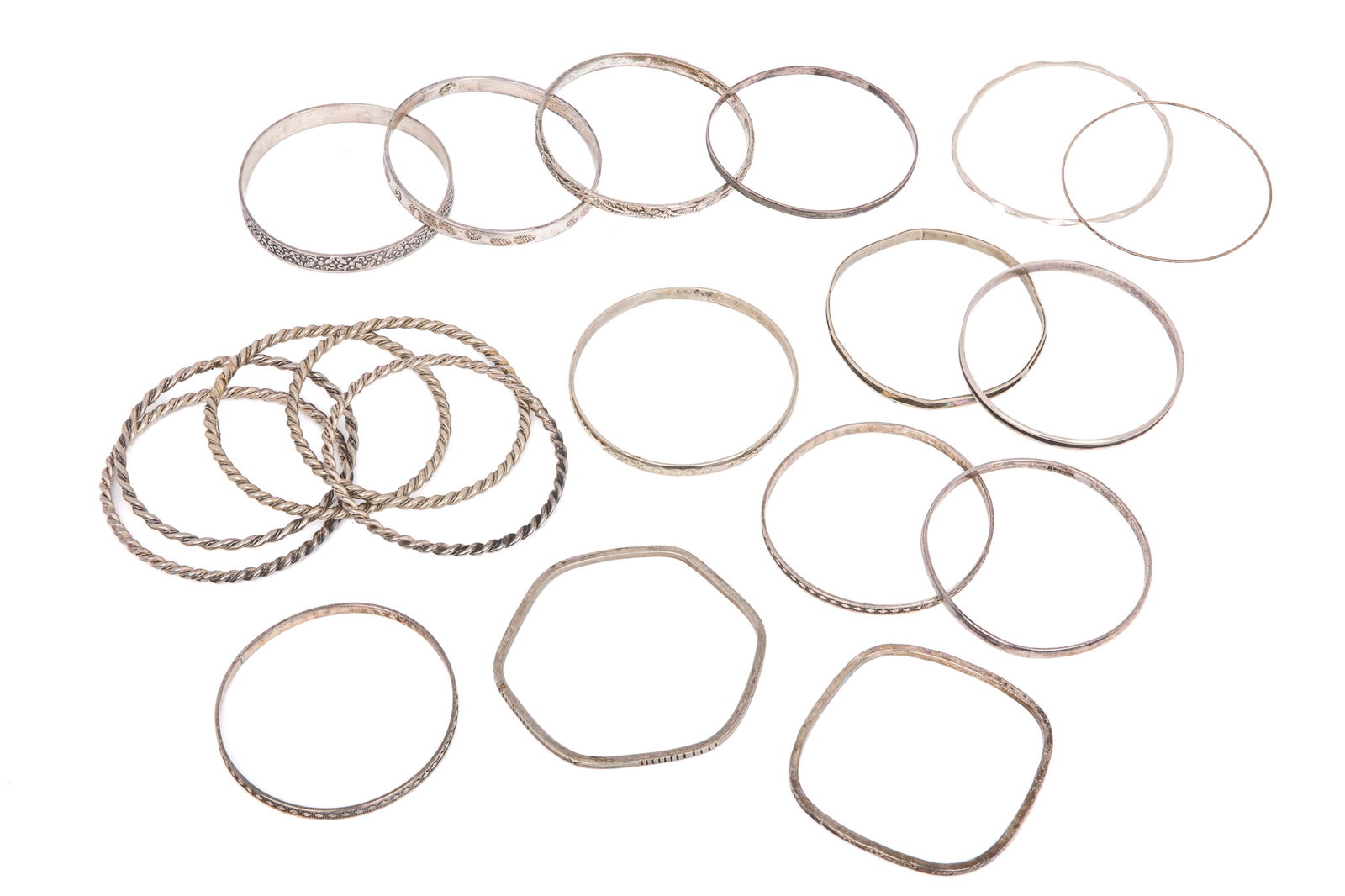 MIXED SILVER BANGLE GROUPING 233g: 5 bangles stamped sterling/925. 47.7 grams 4 Mexican silver bangles. 54.6 grams1 inlay bangle (most inlay gone) testing approximately sterling. 5.5 grams 5 artisan made twisted wire bangles, stamped 9