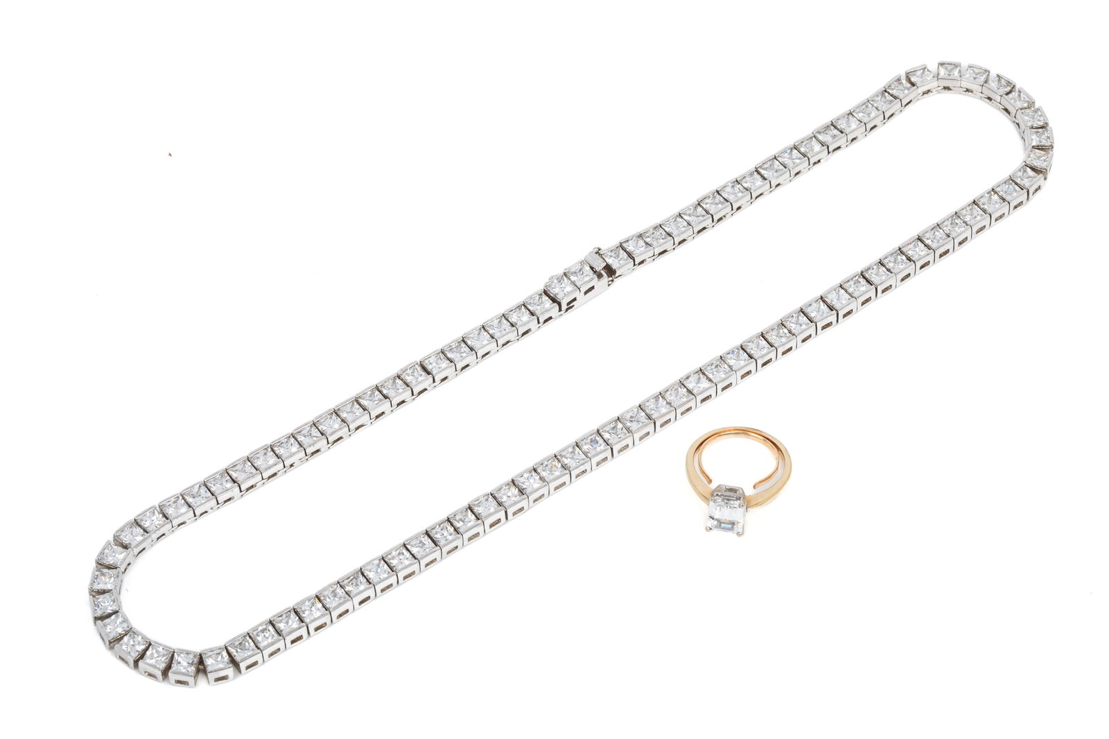 14K & STERLING CZ JEWELLERY PAIRING: 14K yellow and white gold solitaire setting with permanent ring guard (to reduce spinning), featuring 1 emerald cut cubic zirconia measuring 8 x 6mm.Size 5 (approximate) 3.1 grams Sterling silver