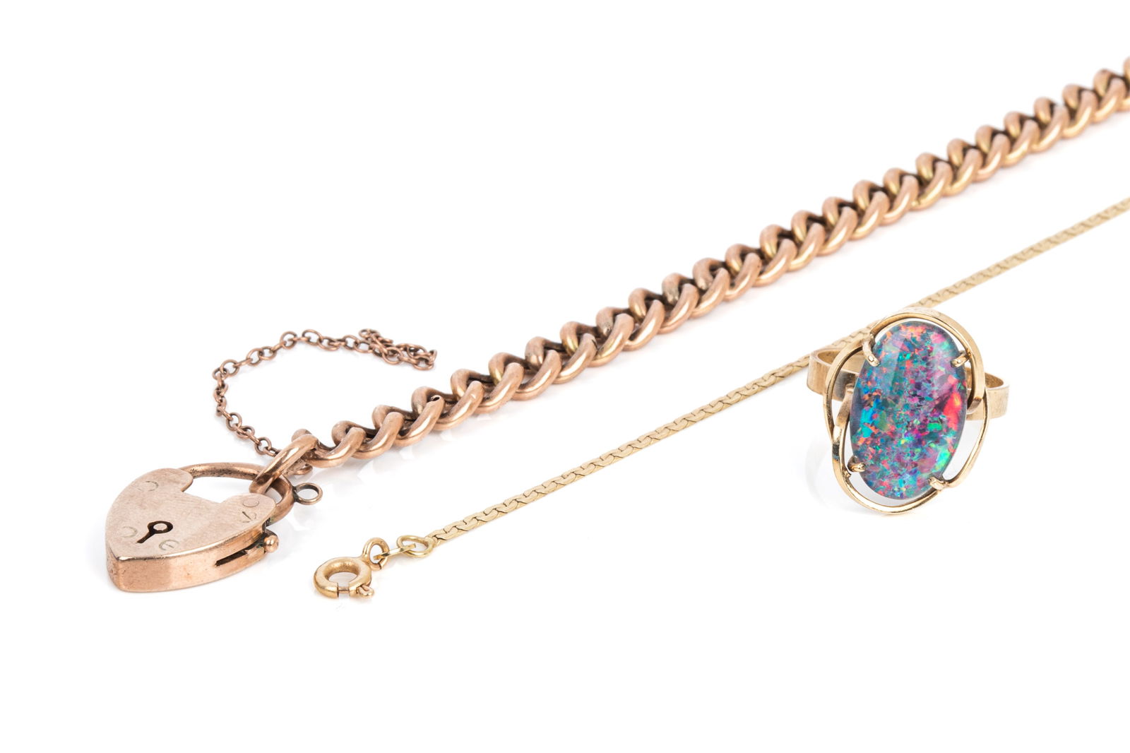 9K & 14K GOLD JEWELLERY GROUPING 13g: 9K rose gold heart lock bracelet measuring 7.75 inches long by 5.9mm wide, safety chain broken. 8.6 grams 14K yellow gold bracelet measuring 7.25 incheslong by 1.4mm wide. 1.3 grams 9K yellow gold