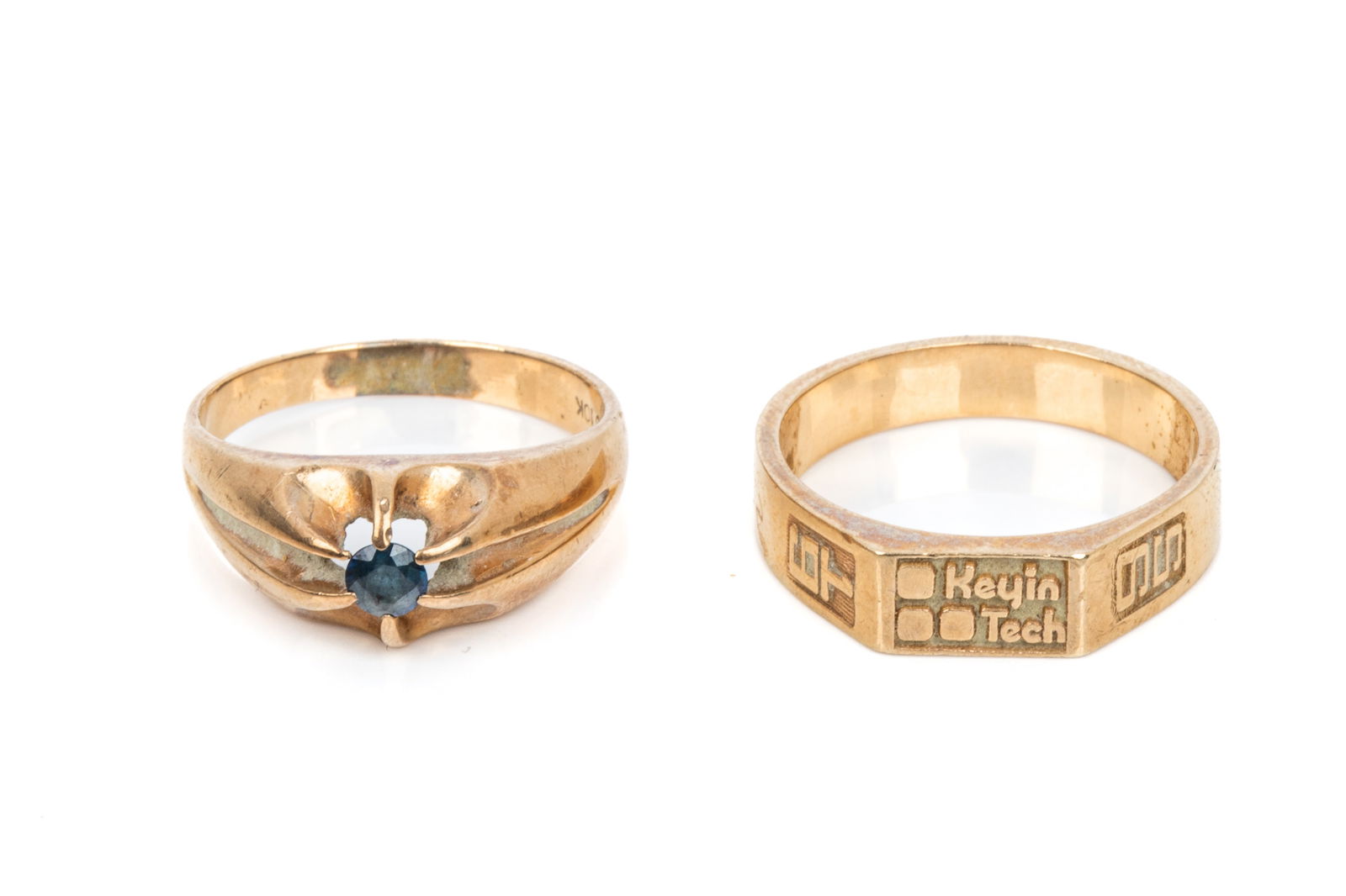 2 10K GOLD GENTS RINGS 9.5g: 10K yellow gold belcher style pale blue sapphire ring measuring 8.7mm wide. Size 9.25 4.2 grams10K yellow gold company ring. 5.3 grams