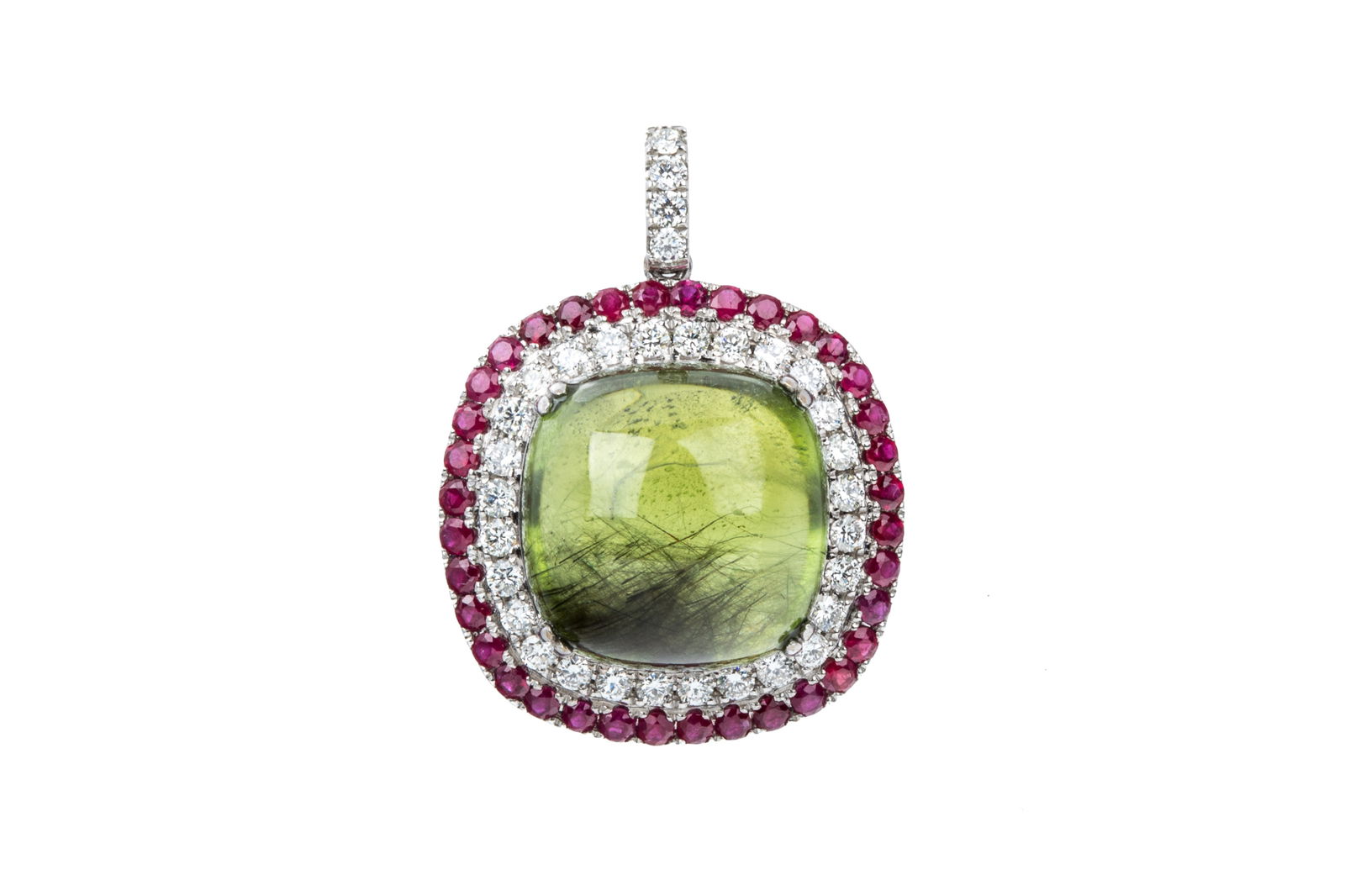 18K PERIDOT, RUBY, & DIAMOND PENDANT 13.1g: 18K white gold statement pendant measuring 33.5mm long (with bail) by 25.1mm wide. Featuring cushion shaped cabochon cut natural medium dark yellowish green peridot, heavily included with interesting