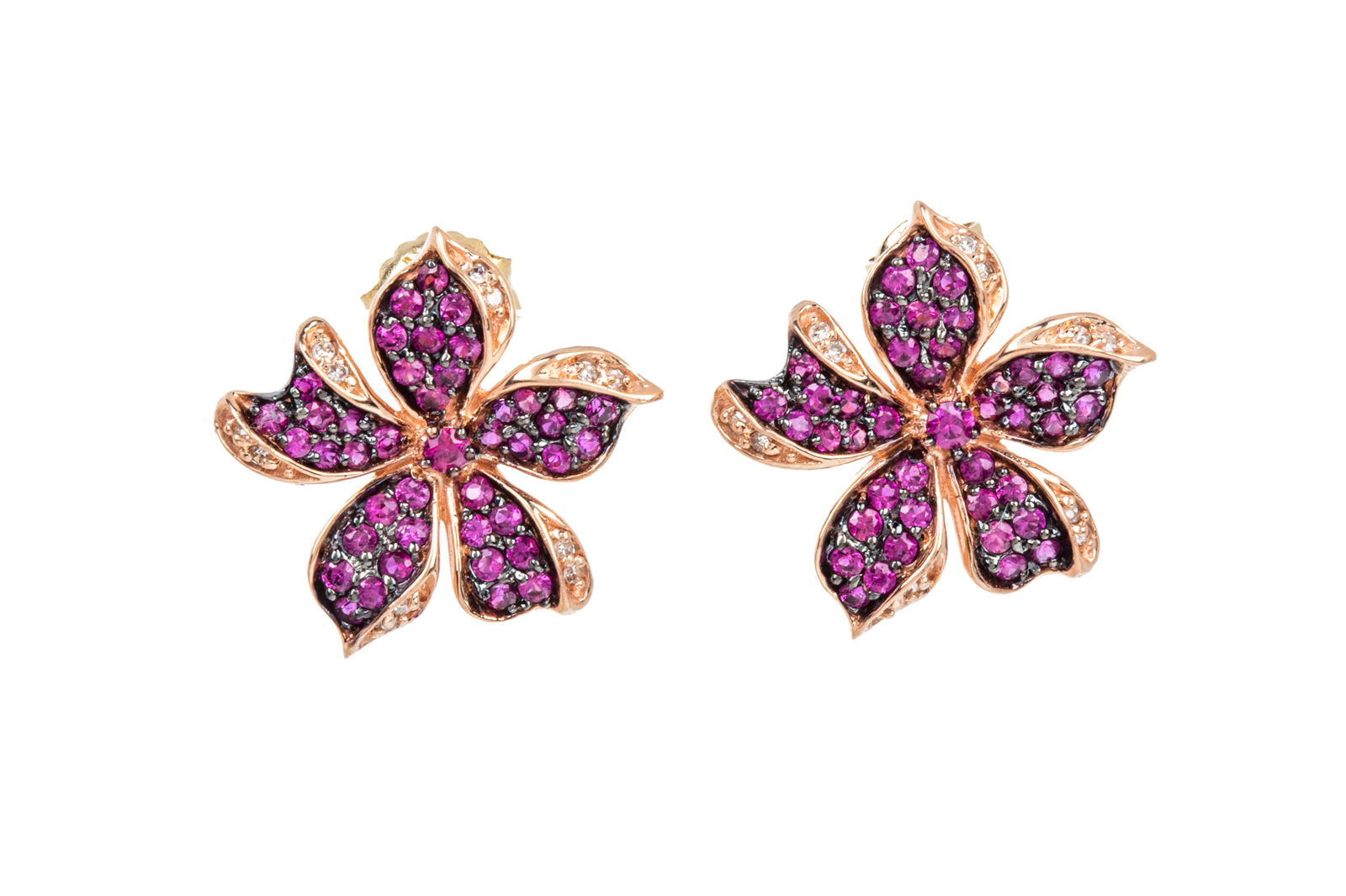 14K PINK SAPPHIRE & DIAMOND EARRINGS 4g: 14K rose gold floral earrings measuring 18.4mm wide, equipped with fixed posts and friction backs. Featuring black rhodium backed, pave and prong set round brilliant cut vivid purplish pink sapphires,