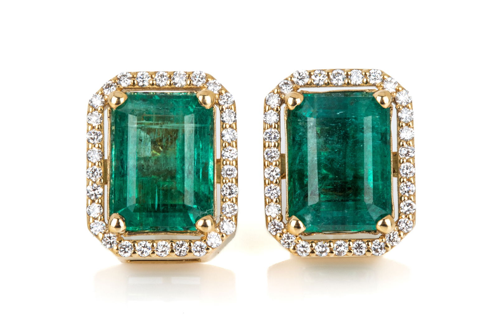 14K 8.20cttw NAT. EMERALD & DIAMOND EARRINGS 7.5g: Custom made 14K yellow gold halo-style earrings measuring 14.1mm long by 11.3mm wide by 9.1mm deep (not including post length), equipped with central posts and heavyweight friction backs. Featuring 2