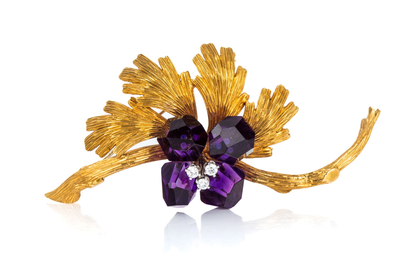 BIRKS 18K AMETHYST & DIAMOND FLORAL BROOCH 15.2g: 18K yellow and white gold vintage floral brooch measuring 59.3mm by 28.5mm, equipped with yellow gold hinge and trombone clasp, white gold pin. Featuring 4 briolette cut half drilled amethysts in rich