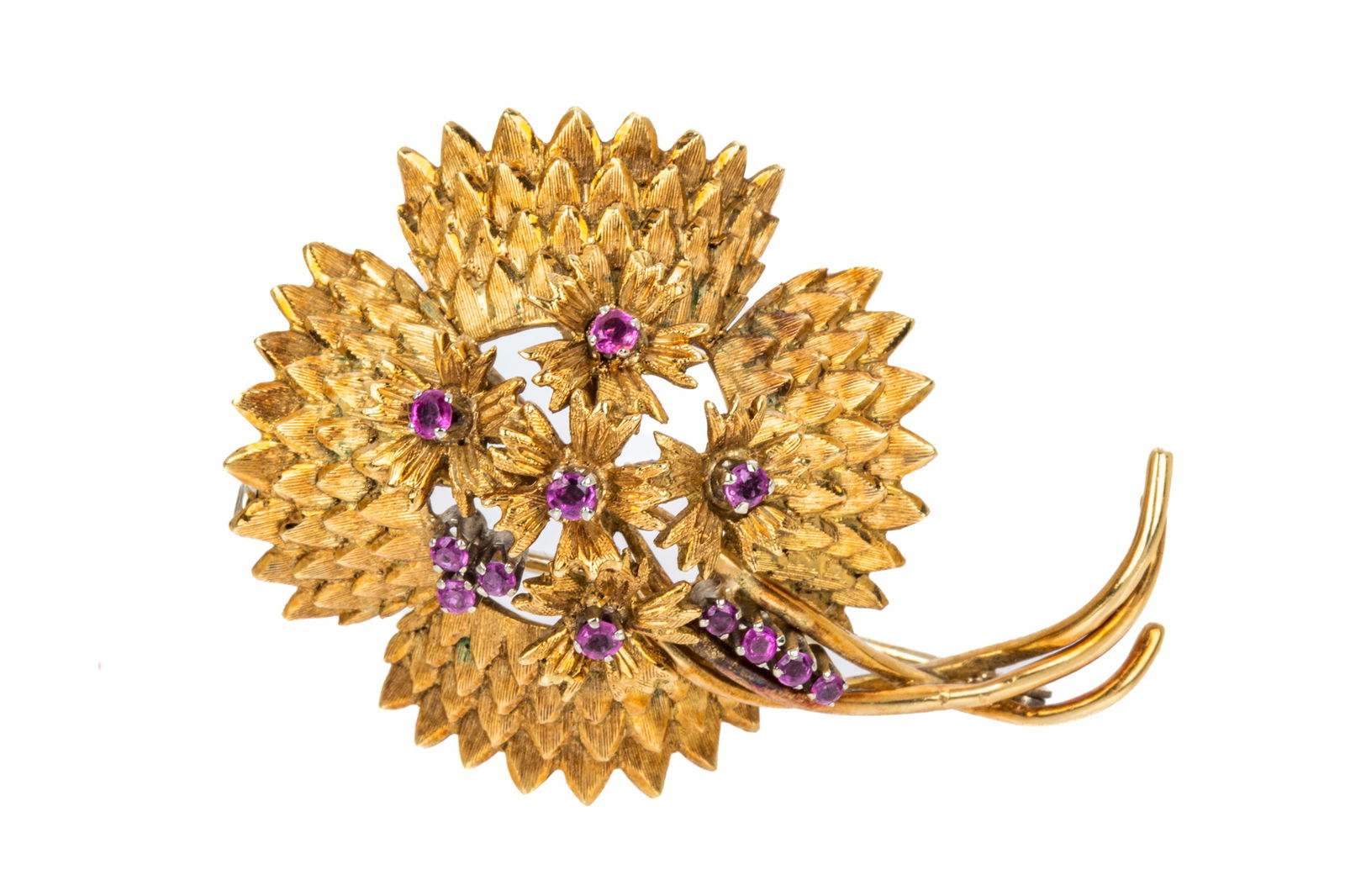 18K ITALIAN FLORAL PURPLE SAPPHIRE BROOCH 15.7g: 18K yellow and white gold floral brooch measuring 46.3mm by 33.3mm, equipped with modern hinge and white gold trombone clasp and brooch pin. Decorated with 12 petite round brilliant cut reddish purple