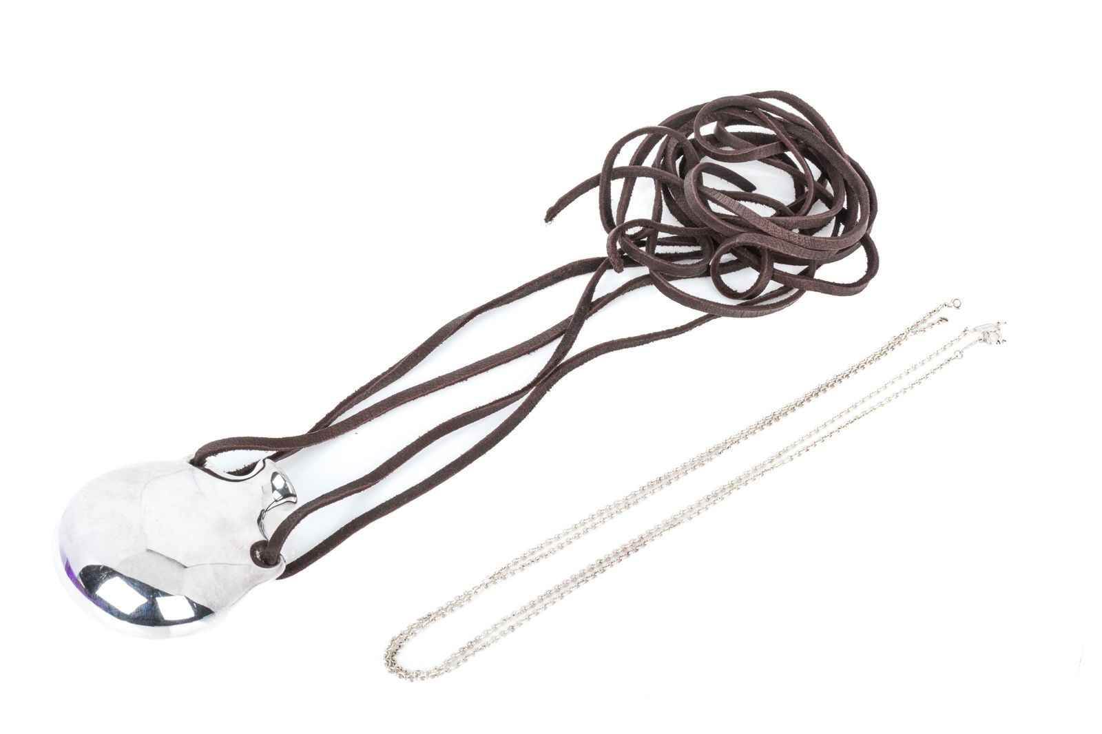 TIFFANY & CO. ELSA PERETTI OPEN BOTTLE PENDANT: Tiffany & Co. Elsa Peretti Bottle Open Bottle Pendant size Large in sterling silver, made in Spain, measuring 65.4mm long by 54.8mm wide by 26.2mm thick. Currently strung from dark brown leather cords