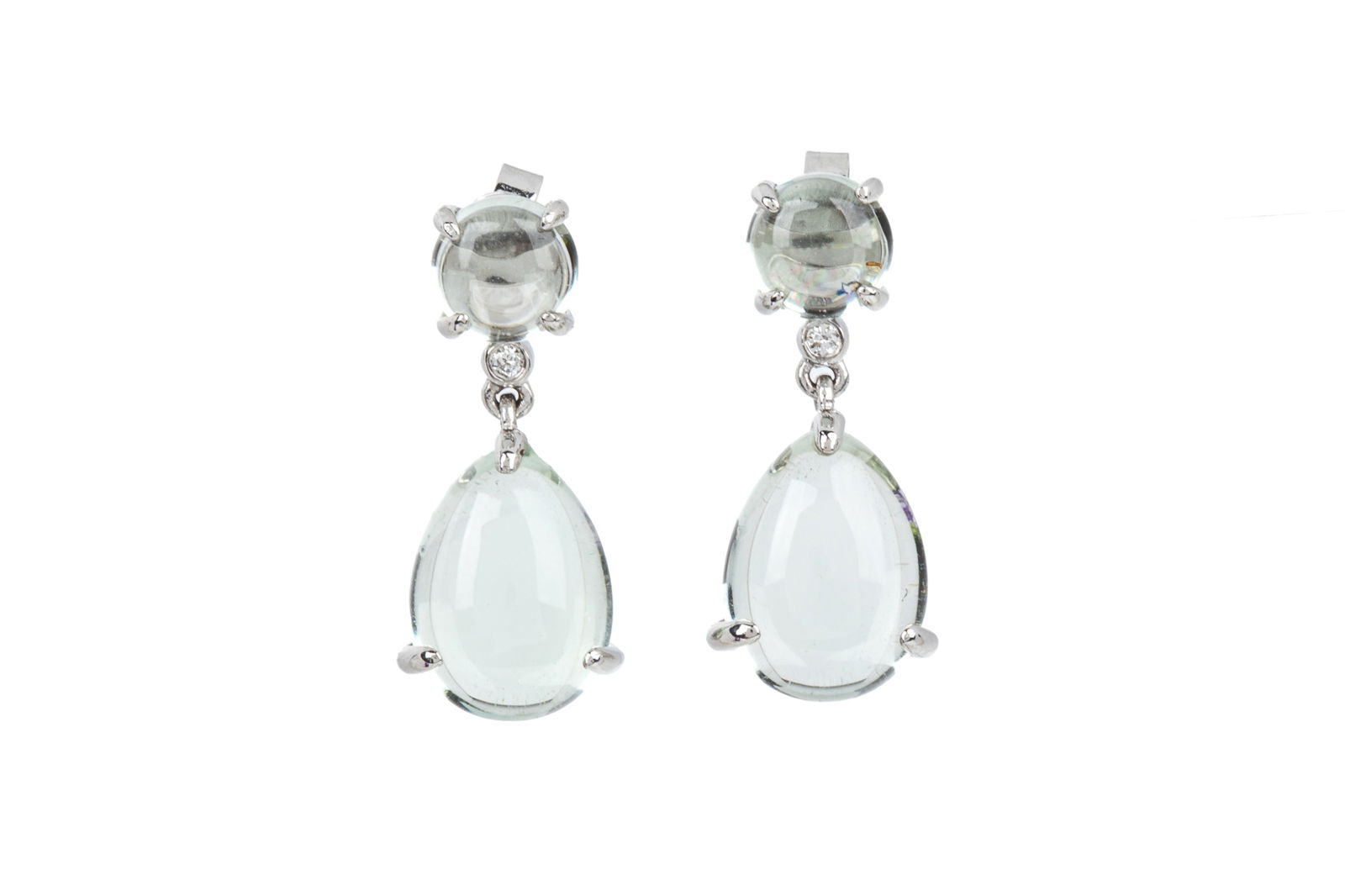 14K GREEN QUARTZ & DIAMOND DROP EARRINGS 4.9g: 14K white gold drop earrings measuring 23.9mm long by 10.2mm wide, equipped with fixed posts and friction backs. Featuring round and pear shaped cabochon cut pale green quartz accented by 2 bezel set