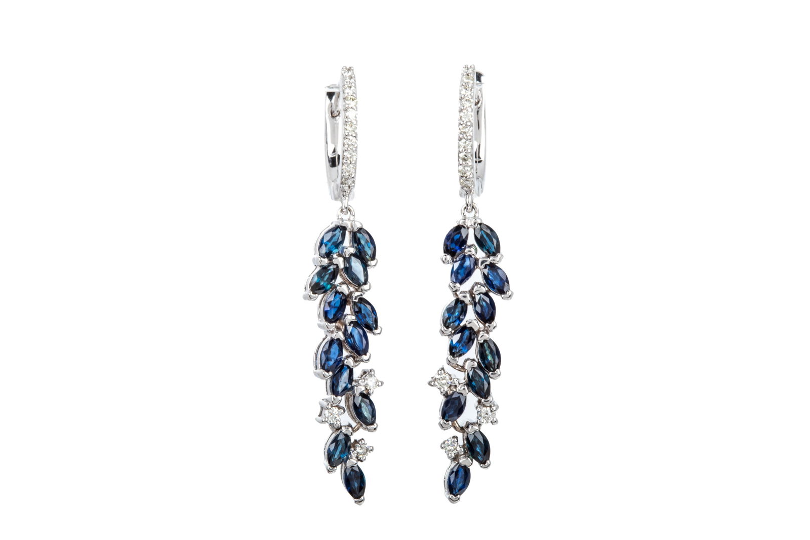 EFFY 14K SAPP. & DIA. ARTICULATED EARRINGS 6.2g: Effy 14K white gold articulated earrings measuring 40.3mm long by 7mm wide, equipped with huggie style closures. Featuring 24 marquise brilliant cut medium dark blue sapphires accented by 26 round bri